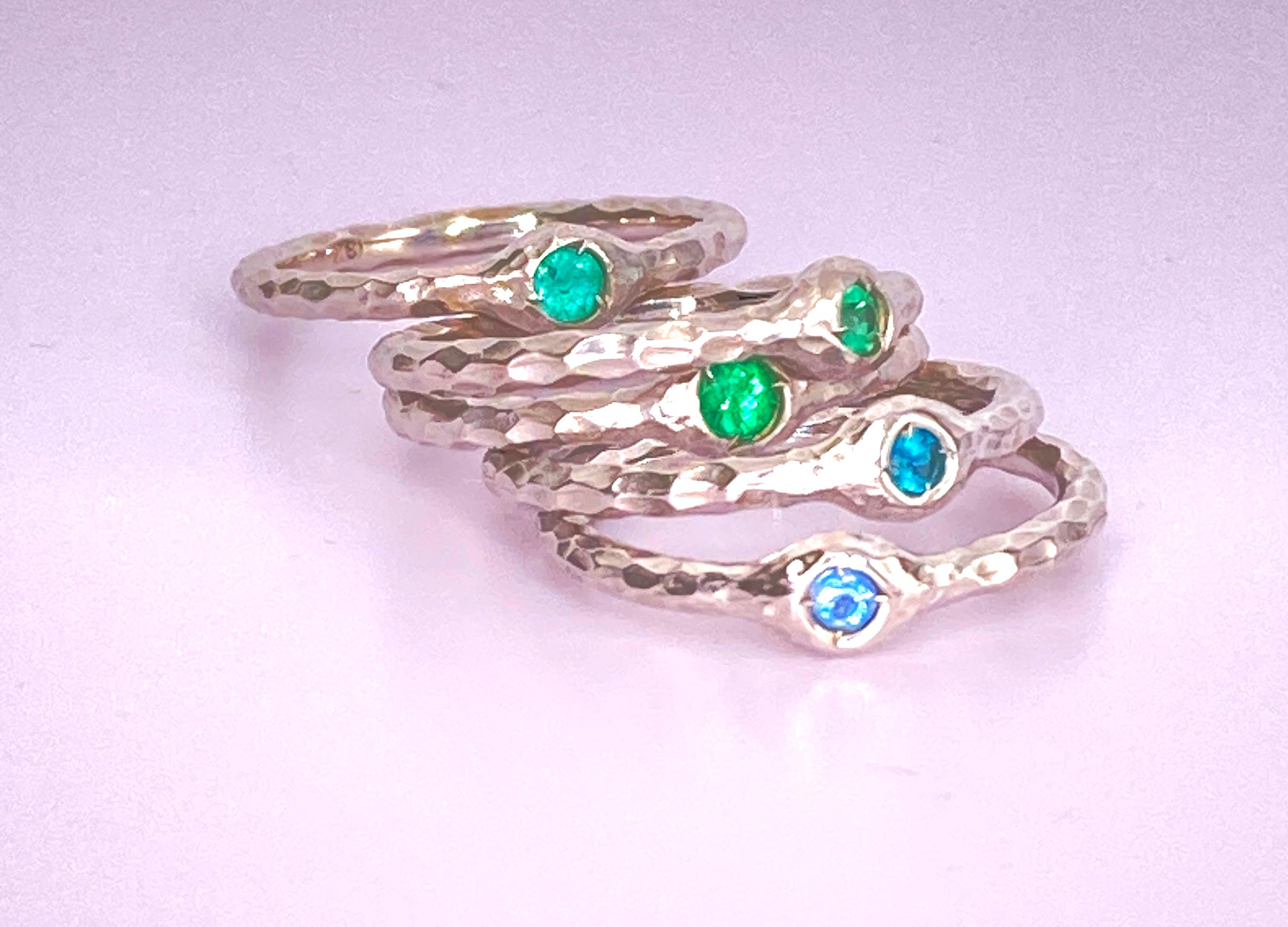 With these five Brazilian Paraiba Tourmaline you have the whole palette of blue and green they're famous for. The hammered bands are 18 Kt white gold and sand blasted. they can be polisshed.