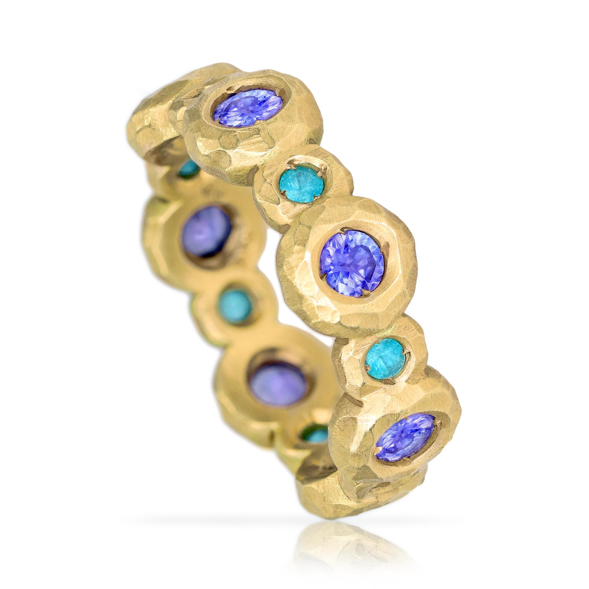Tropical Crush Eternity Band Ring hand-fabricated by award winning jewelry designer Pamela Froman in her signature, intricately-finished 18k yellow gold featuring gorgeous alternating faceted round Paraiba tourmaline and tanzanite, both precious and