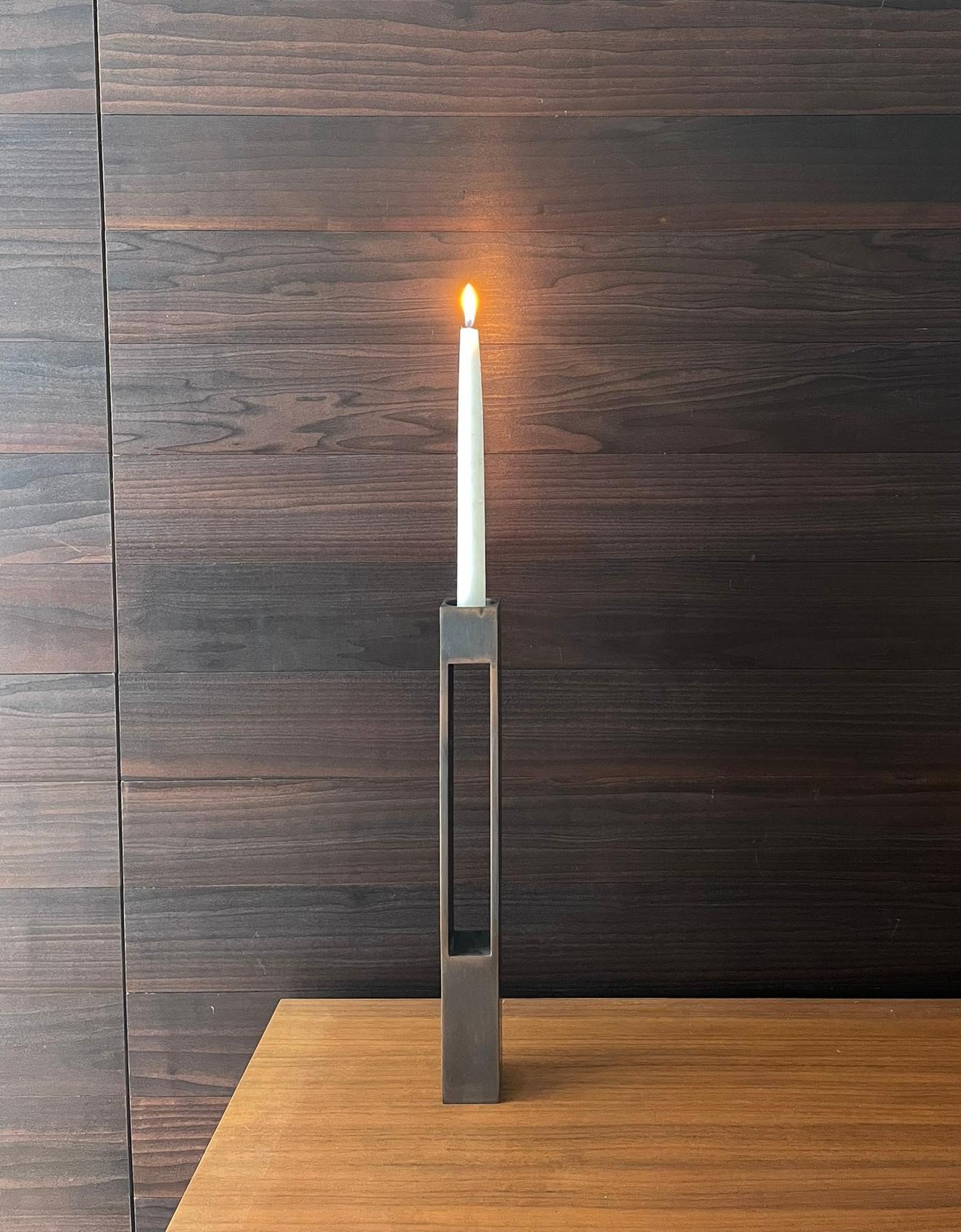 These stately bronze candle holders are pedestals designed to accommodate either tea lights or taper candles. Depending upon your viewing angle, the tall metal candle holders can seem either light and open, or solid and rooted. Both modern and