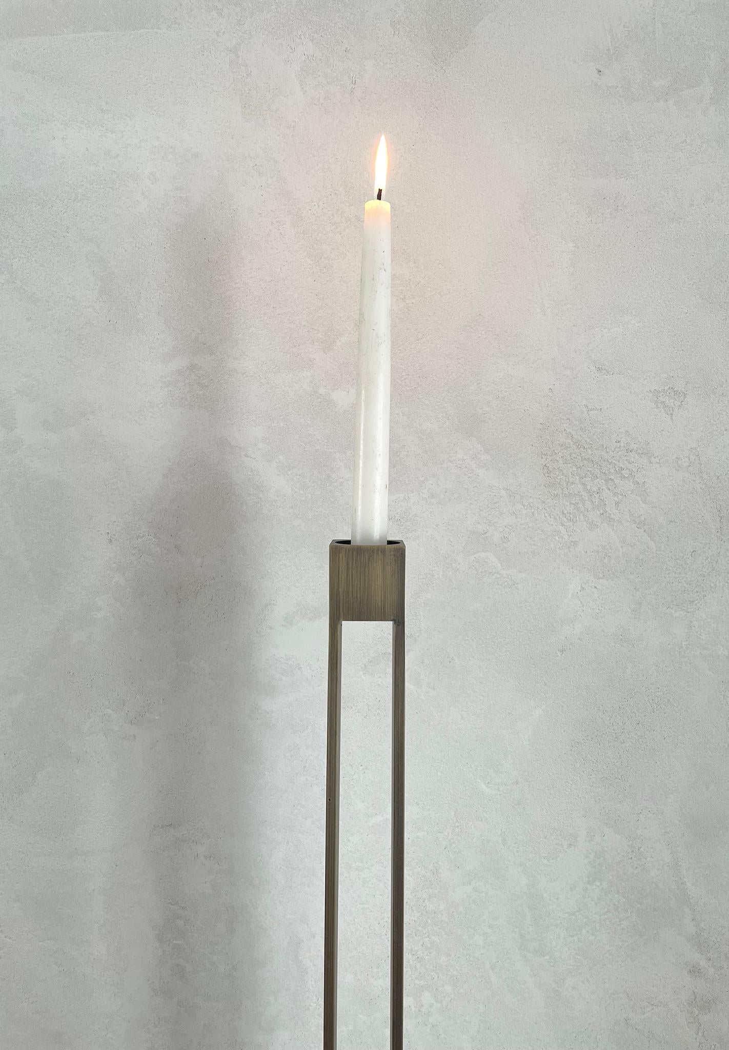 This stately candle holder is designed to accommodate either tea lights or taper candles. Depending upon your viewing angle, the tall metal candle holders can seem either light and open, or solid and rooted. Both modern and timeless, the Parallel