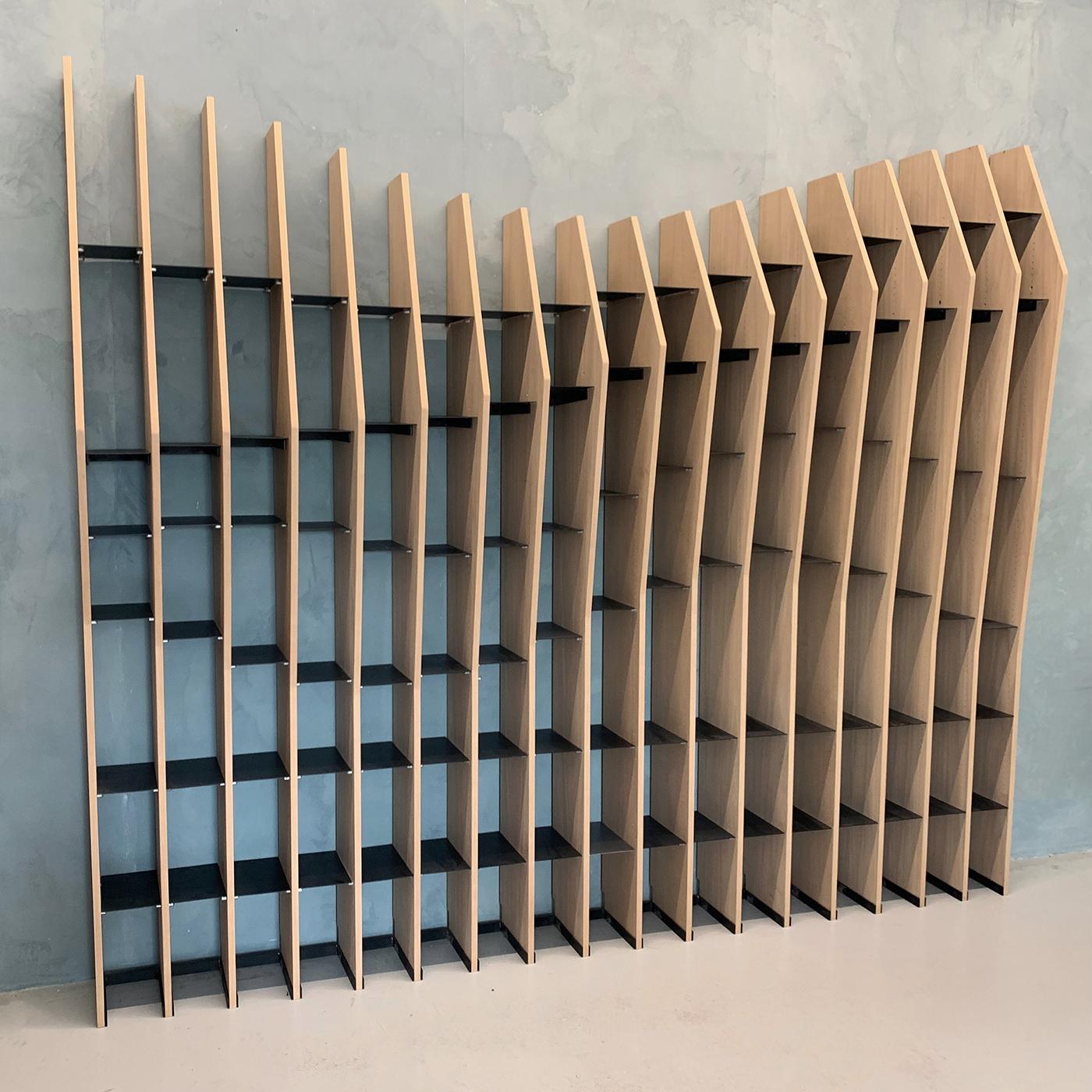 This visually striking, geometric bookshelf is defined by its extremely dynamic appearance, adding a touch of energy and movement to any environment. It is perfect for a home, hospitality environment or business, and can be used to divide an open