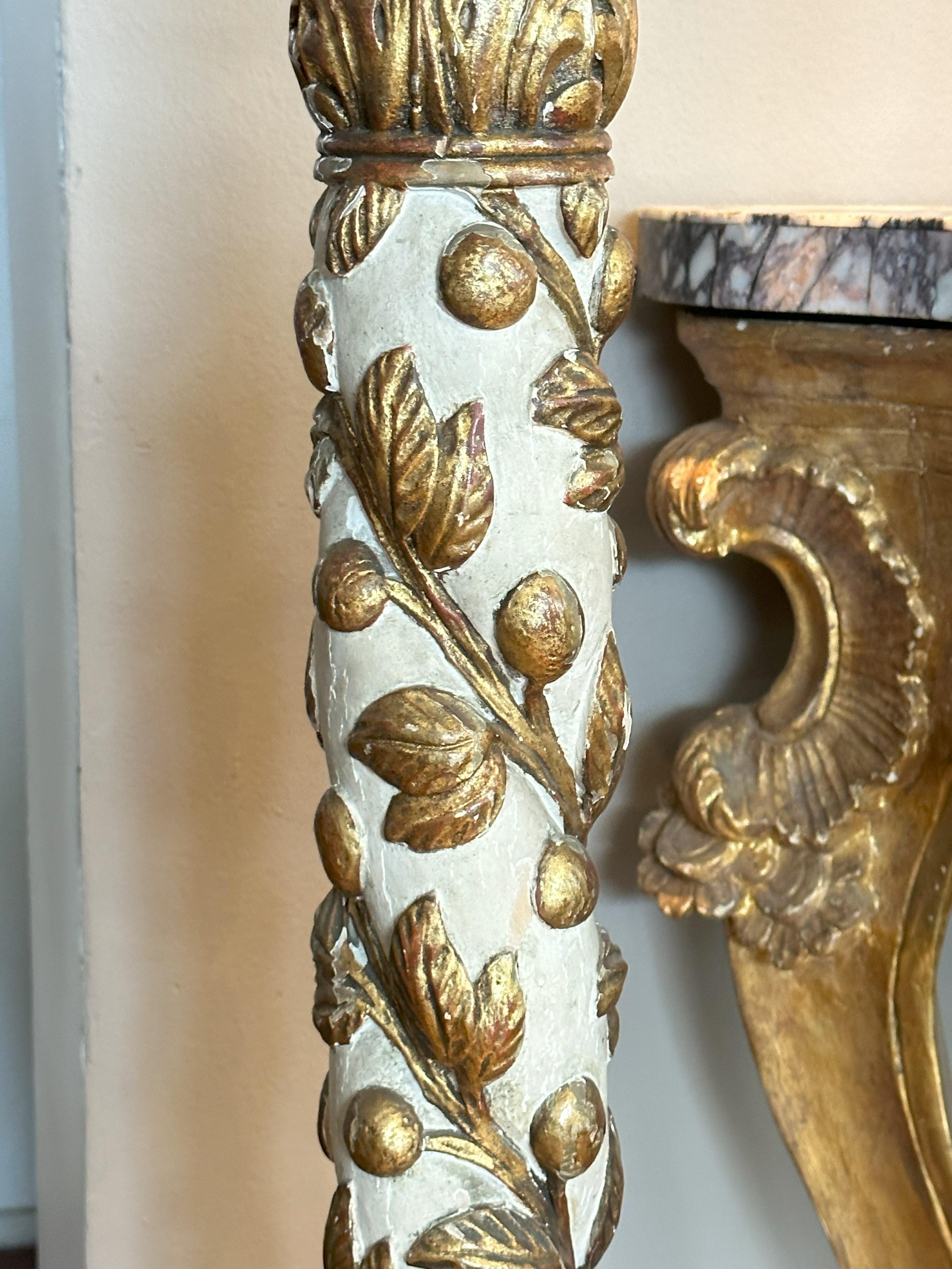 Italian parcel gilt and ivory painted torchere. baluster standard carved with acanthus leaves on a splayed tripod base