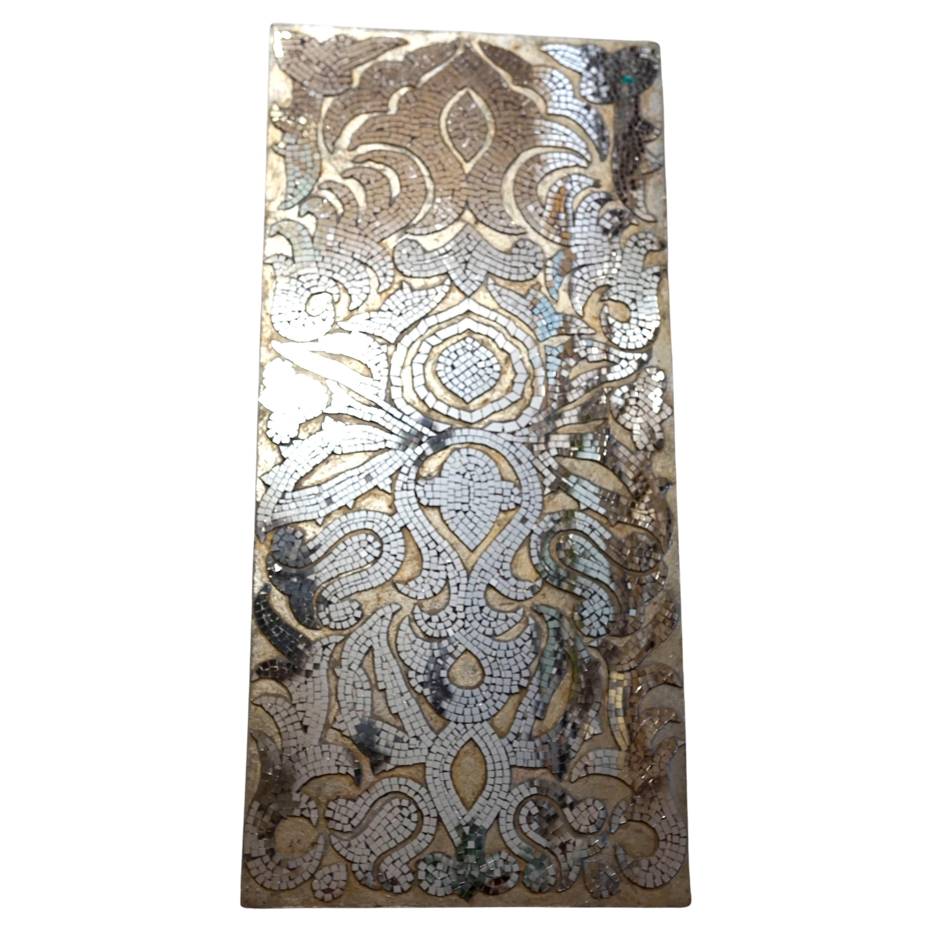 An unusual parcel gilt mirrored mosaic tile wall panel is amazing. It is vintage and art deco style, produced mid-century. Our appraiser says it has a Continental feel, but we are not certain exactly where it was produced. The mirrored tile is cut