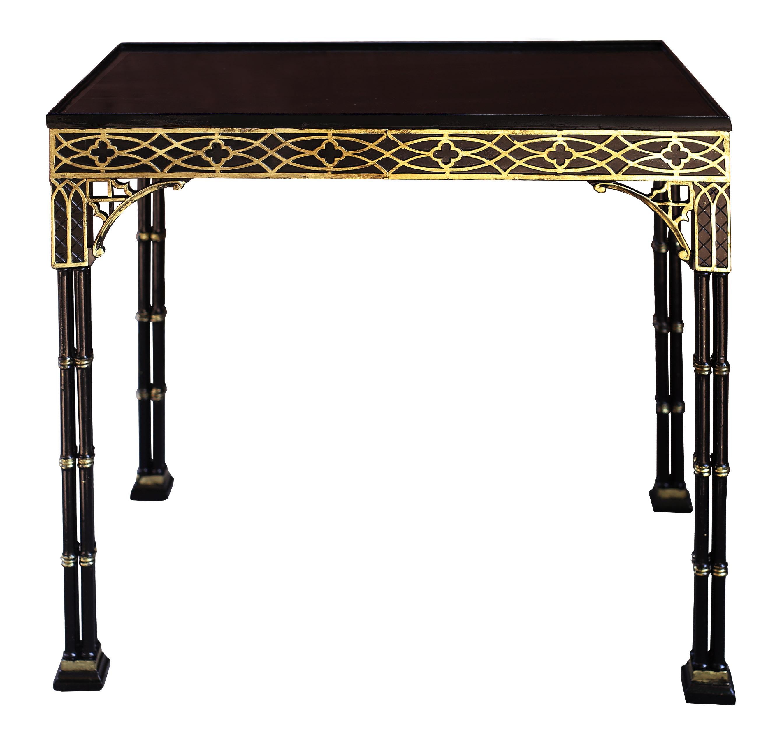 A lovely side or card table of delicate detail and proportion. The frieze of the table features Gothic blind fretwork that is highlighted in 18k gold. The corners are supported by brackets with C-scrolls and lancet arches beneath which extend