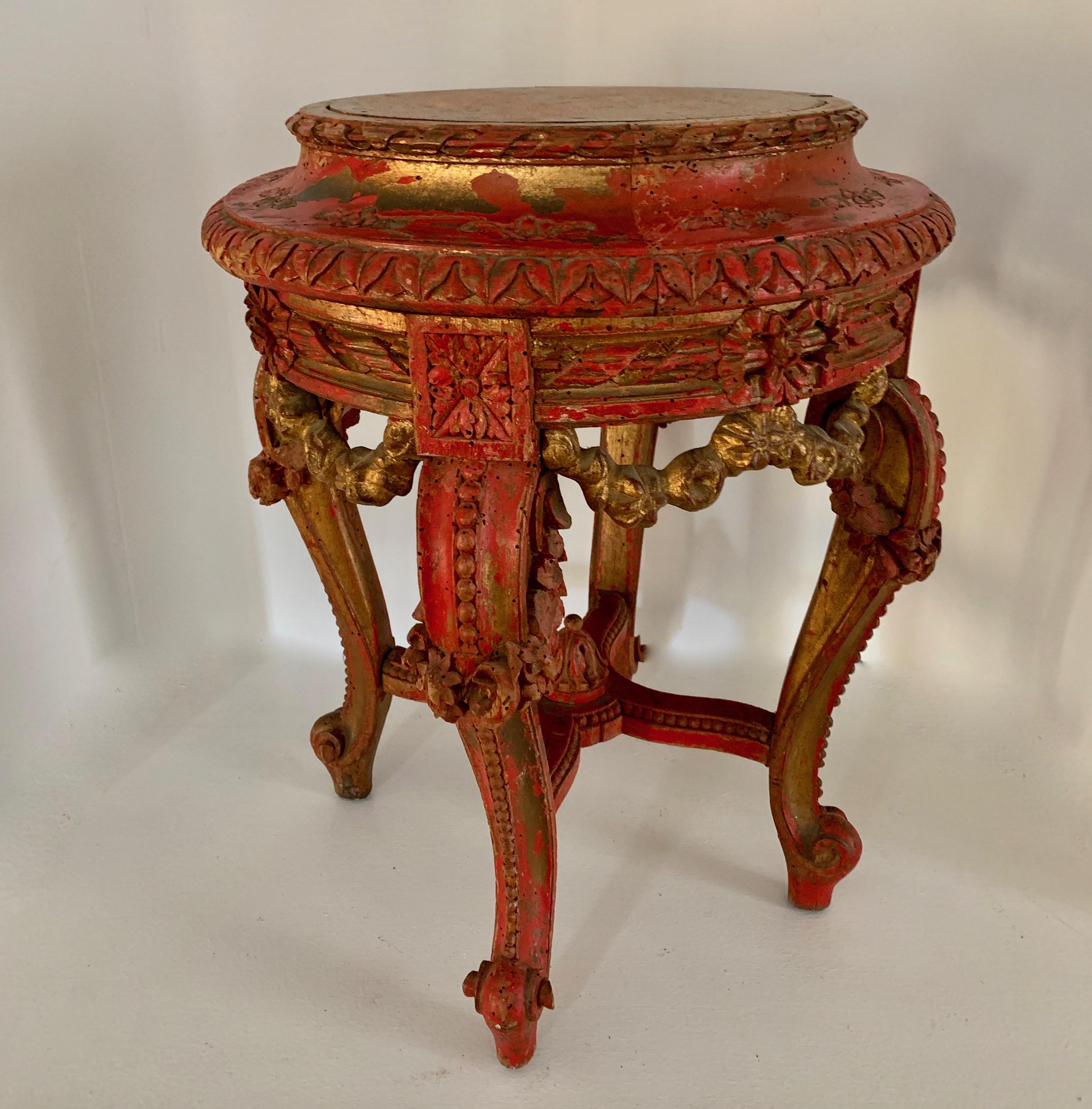 Parcel gilt hand carved French table, small drink table, a wonderful red color with gilding. The table is hand carved and a lovely addition to any room. An additional round piece of glass comes with this piece. Works well in any environment, from