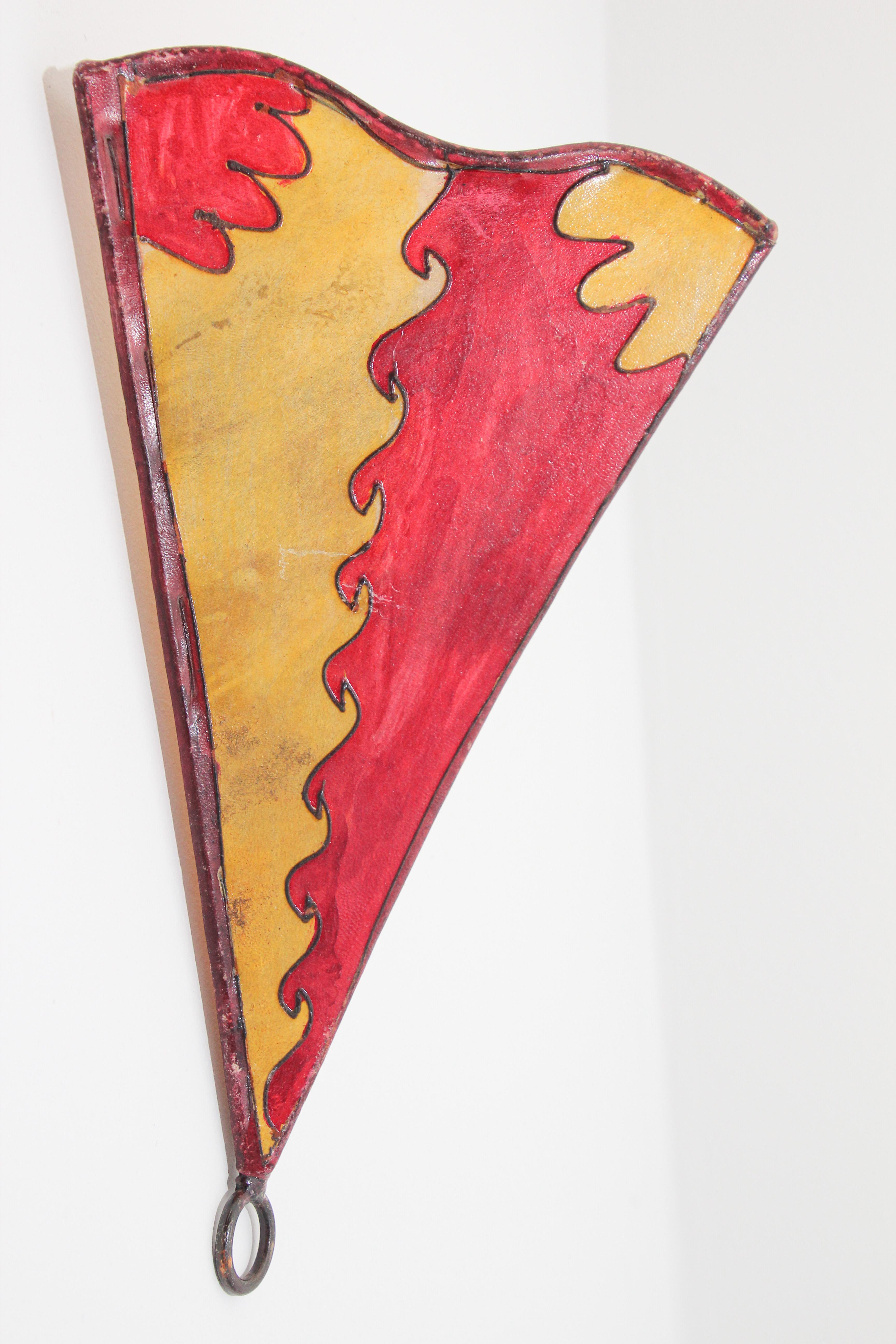 African tribal art parchment wall shade sconce featuring a large triangle hide form stitched on iron and hand painted surface.
These Moroccan art pieces could be used as wall lamp shade.
Iron frame covered with hide parchment which has been hand