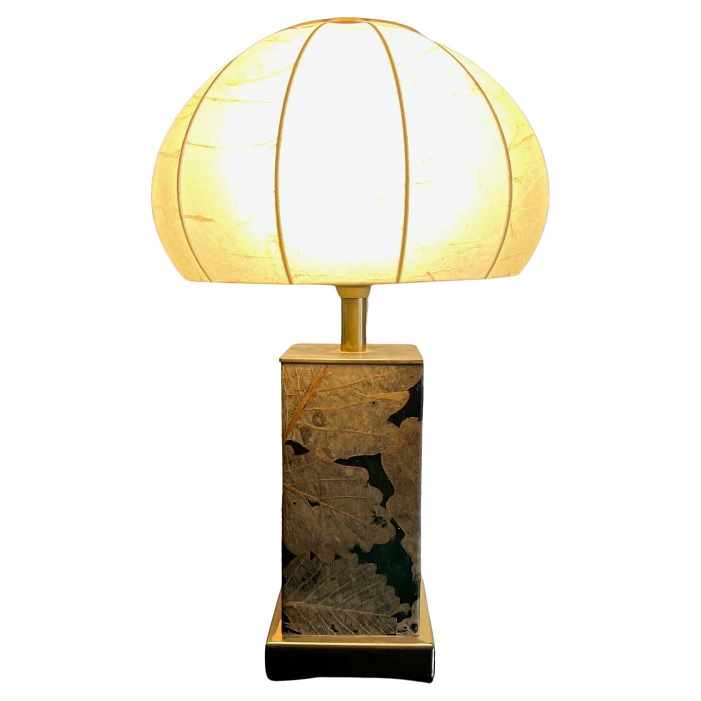 Rare table lamp with inlay of dried leaves on the base, shade made of parchment and brass , edited in the 1970's
Lack of gold on part of the base as pictured.