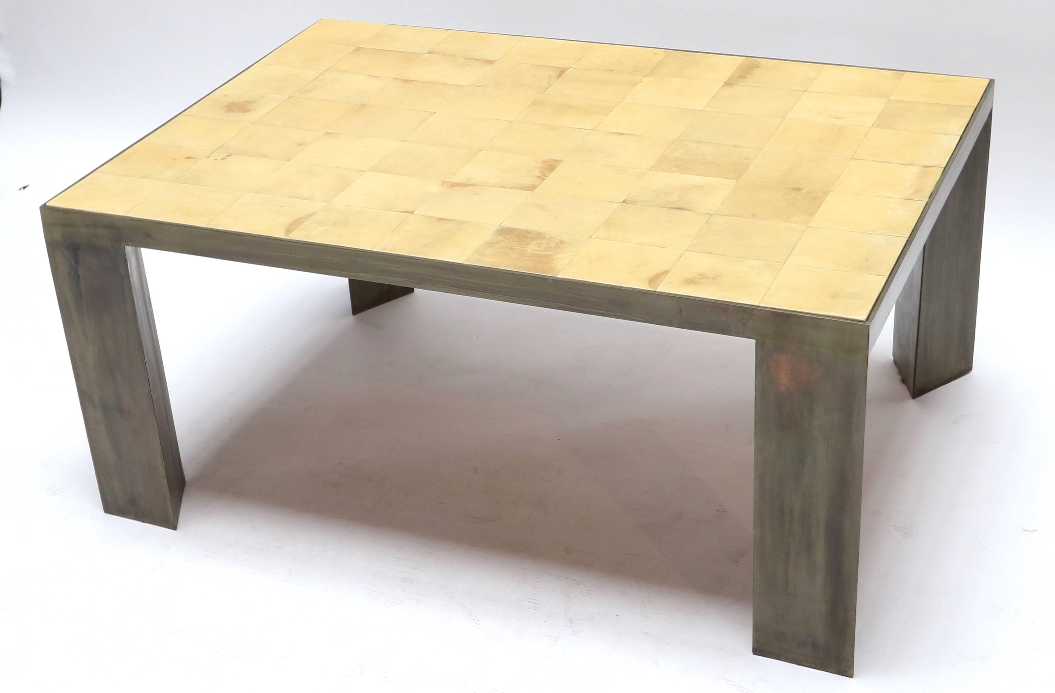 Parchment coffee table with metal legs.