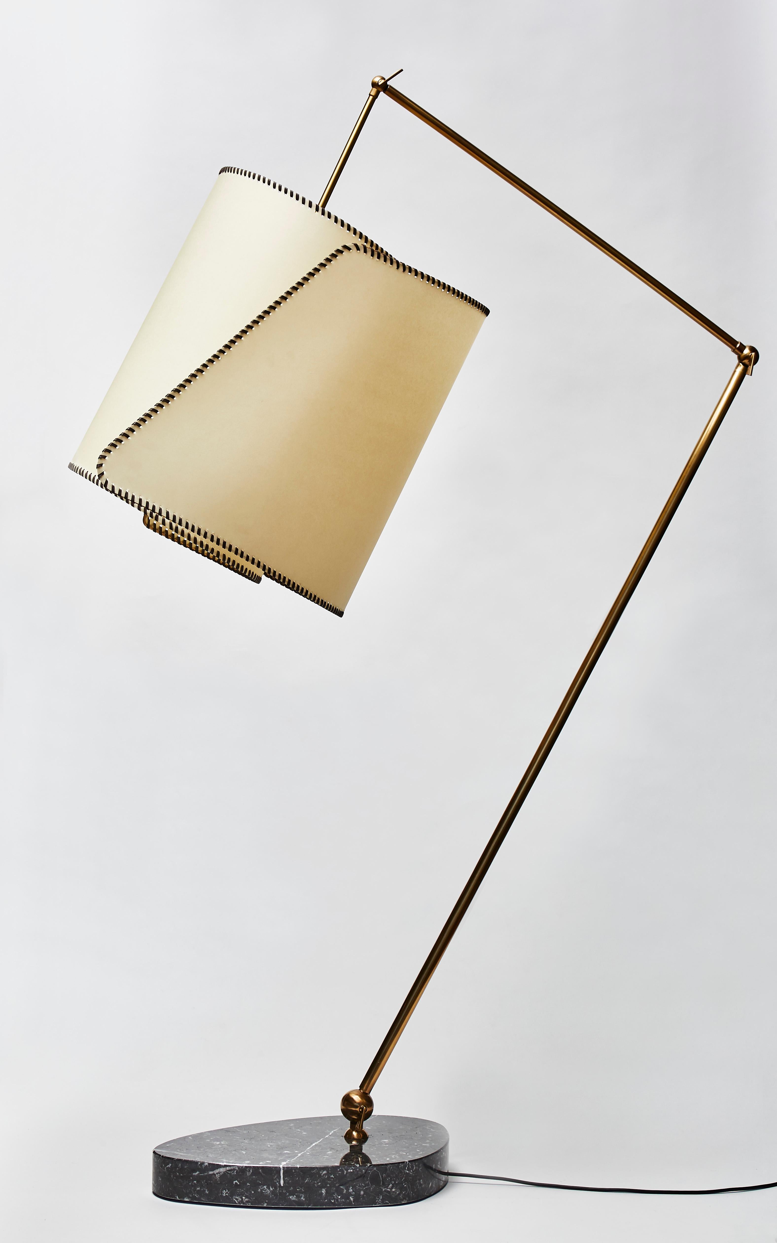 Titta floor lamp by the artist Diego Mardegan exclusively for Glustin Luminaires.

Beautiful vortex shade made of a brass structure, parchemin paper and waxed fabric hold by a patined articulated brass arm attached to a grey marble foot.