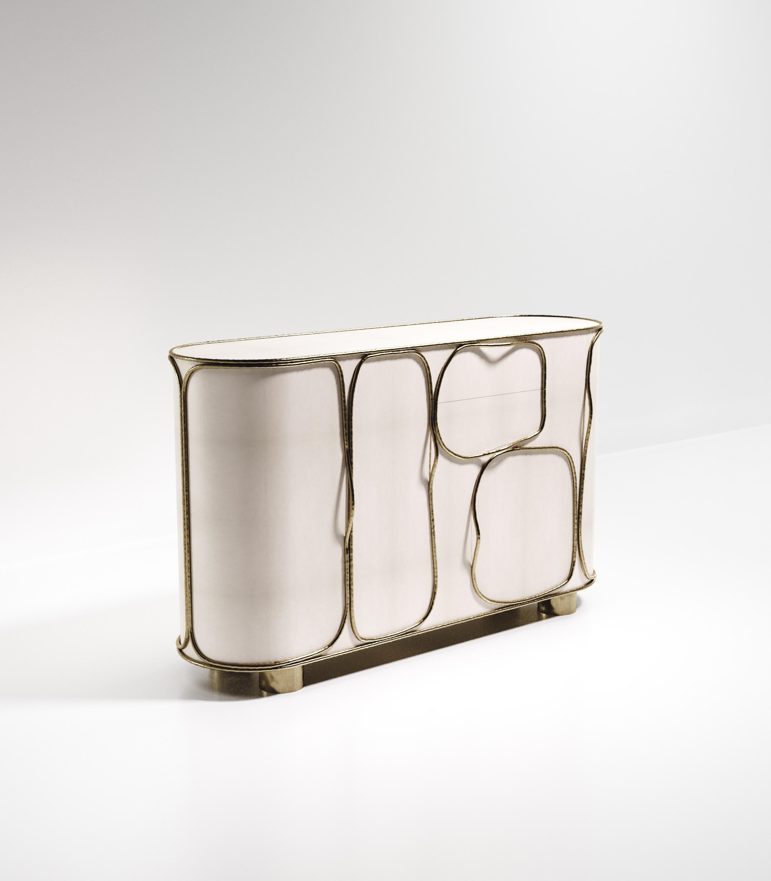 The Arianne buffet by R&Y Augousti is one of a kind statement piece. The overall piece is inlaid in cream parchment accentuated with intricate bronze-patina brass details that have the signature Augousti 