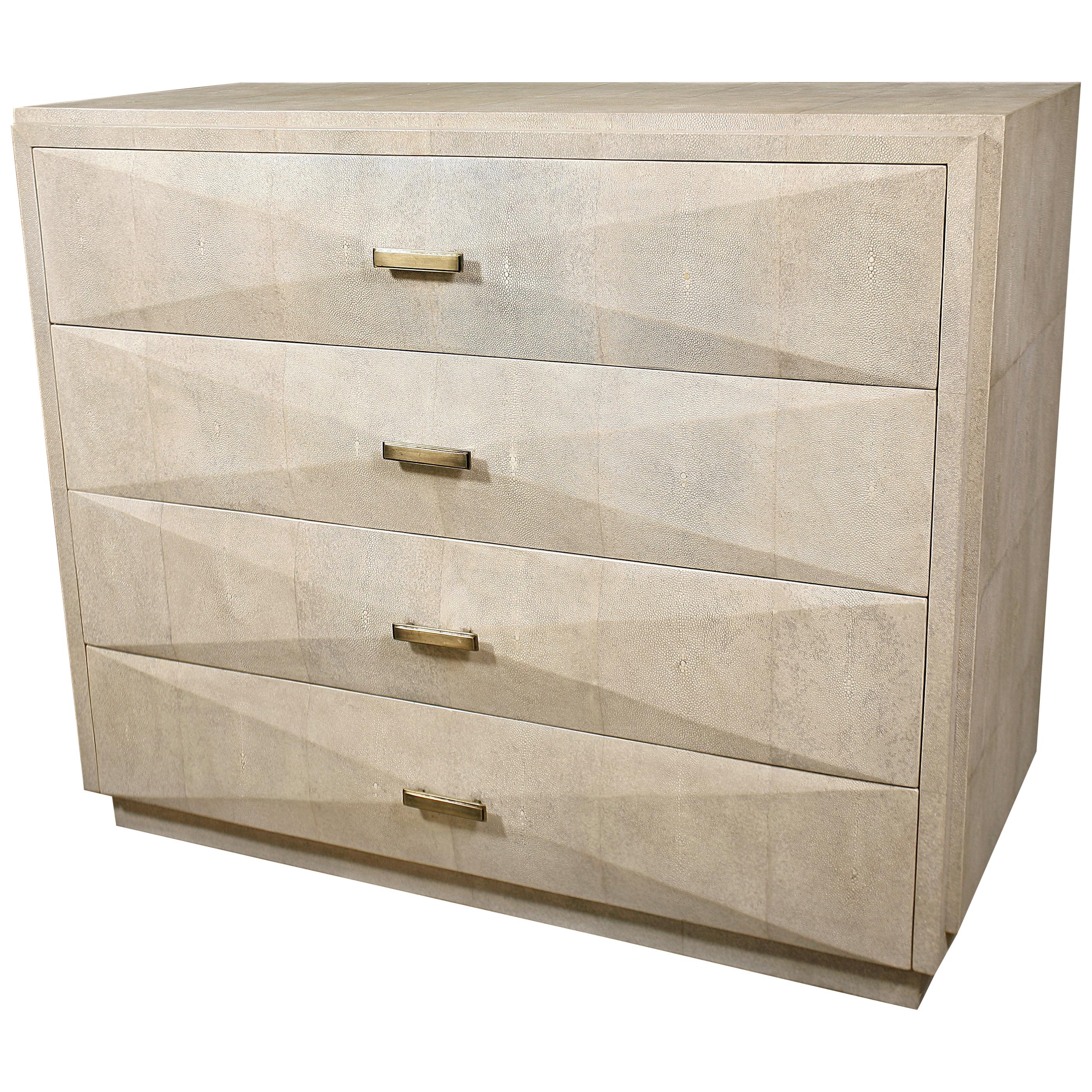 The iconic chest of drawers by R&Y Augousti is one of their first designs. A Classic and functional storage piece, with subtle geometry on the beveled drawers. This chest of drawers is completely inlaid in cream parchment with discreet bronze-patina