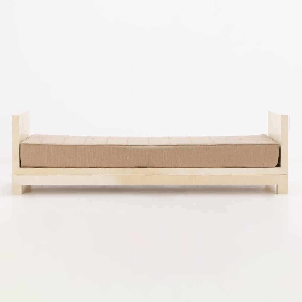 Parchment covered three-piece daybed in the manner of Jean-Michel Frank. Having a detachable tan cushion.