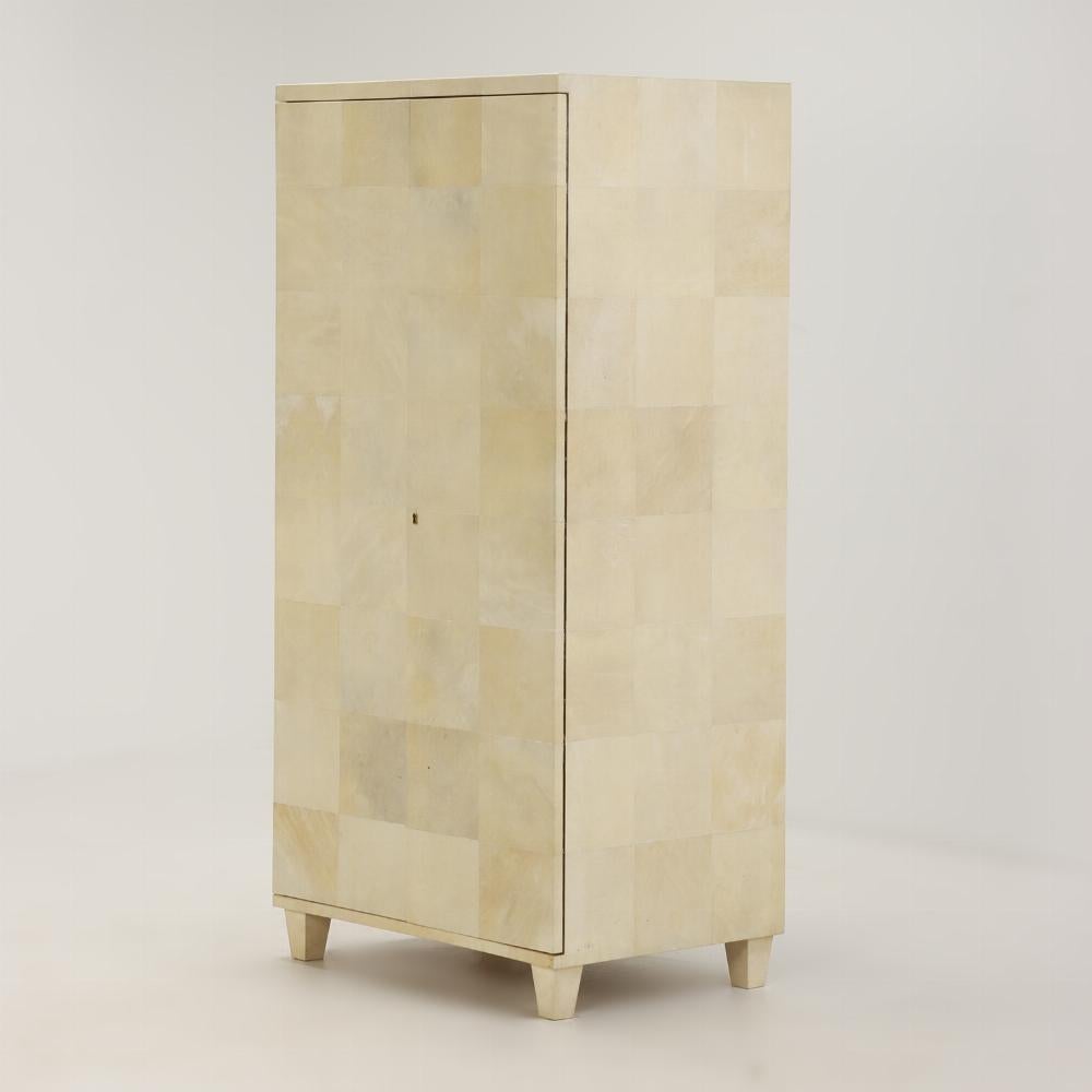 Parchment covered two door cabinet C 1940 in the manner of Samuel Marx. The case covered in parchment with a patchwork design opening to three shelves.