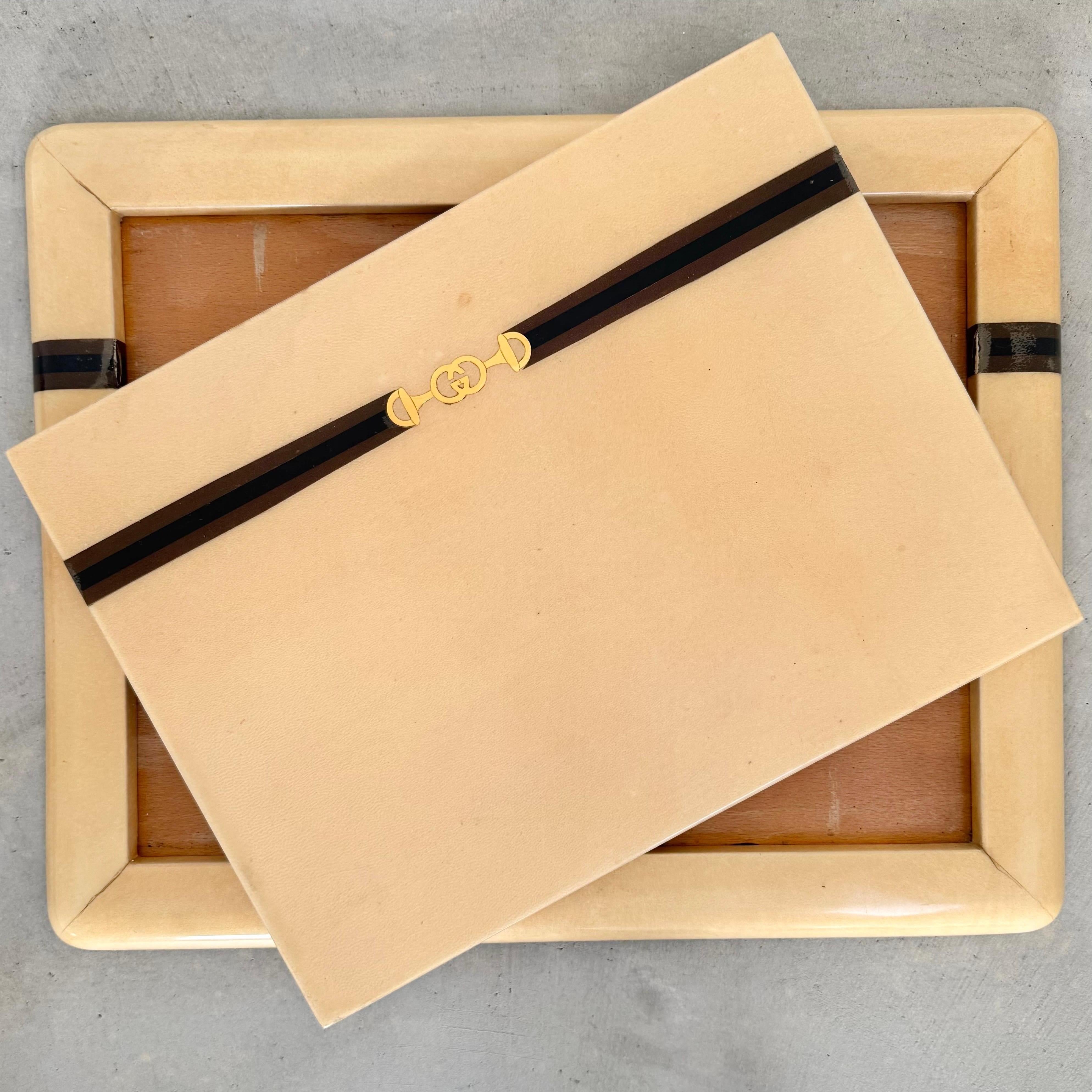 Incredibly rare vintage portable writing pad by Gucci circa 1930s. Parchment exterior and a wood frame, featuring brown felt underneath. Removable inset top reverses to a parchment writing surface with 4 brown leather corners to hold papers. Brown