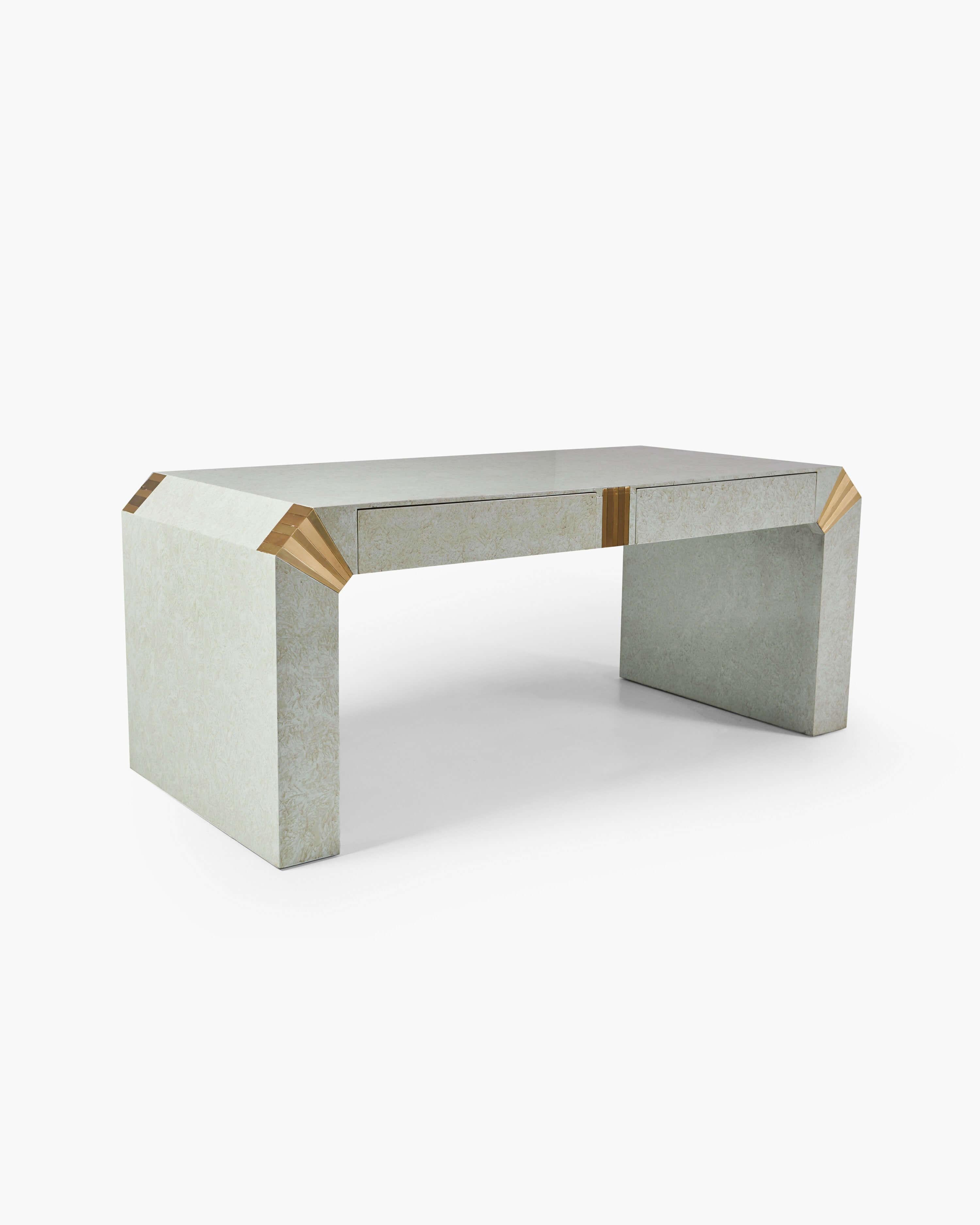 This 1970s desk achieves a modest stateliness, its mottled paper parchment & faceted brass corners showcasing superb attention to detail. The seamless integration of variant textures & finishes is in keeping with its modernist heritage, elevating