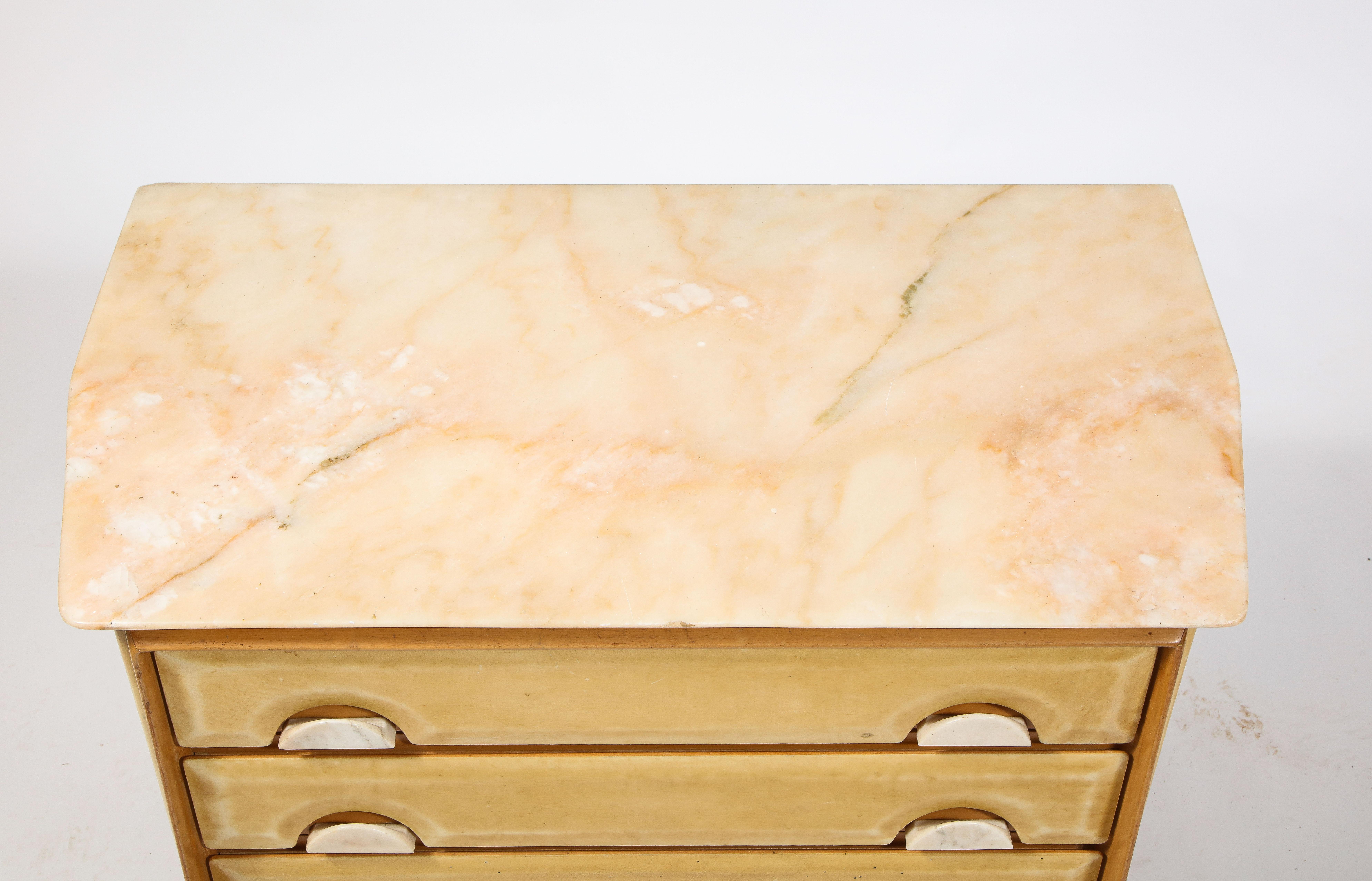 Beech commode covered in parchment, each face has a subtly different angle. The top is a pink-hued marble also used for handles.