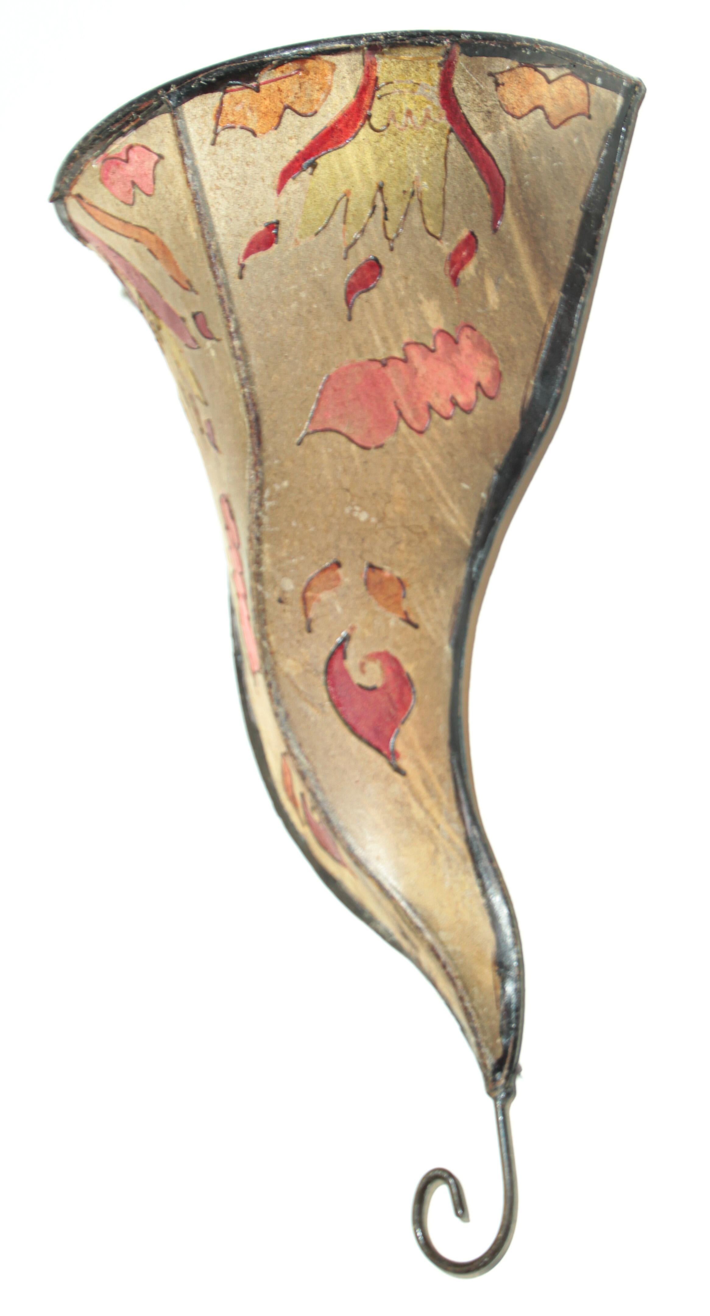 African Tribal Art parchment wall shade sconce featuring a large curved hide form stitched on iron and hand painted surface.
These Moroccan Art pieces could be used as wall lamp shade.
Iron frame covered with hide parchment which has been hand