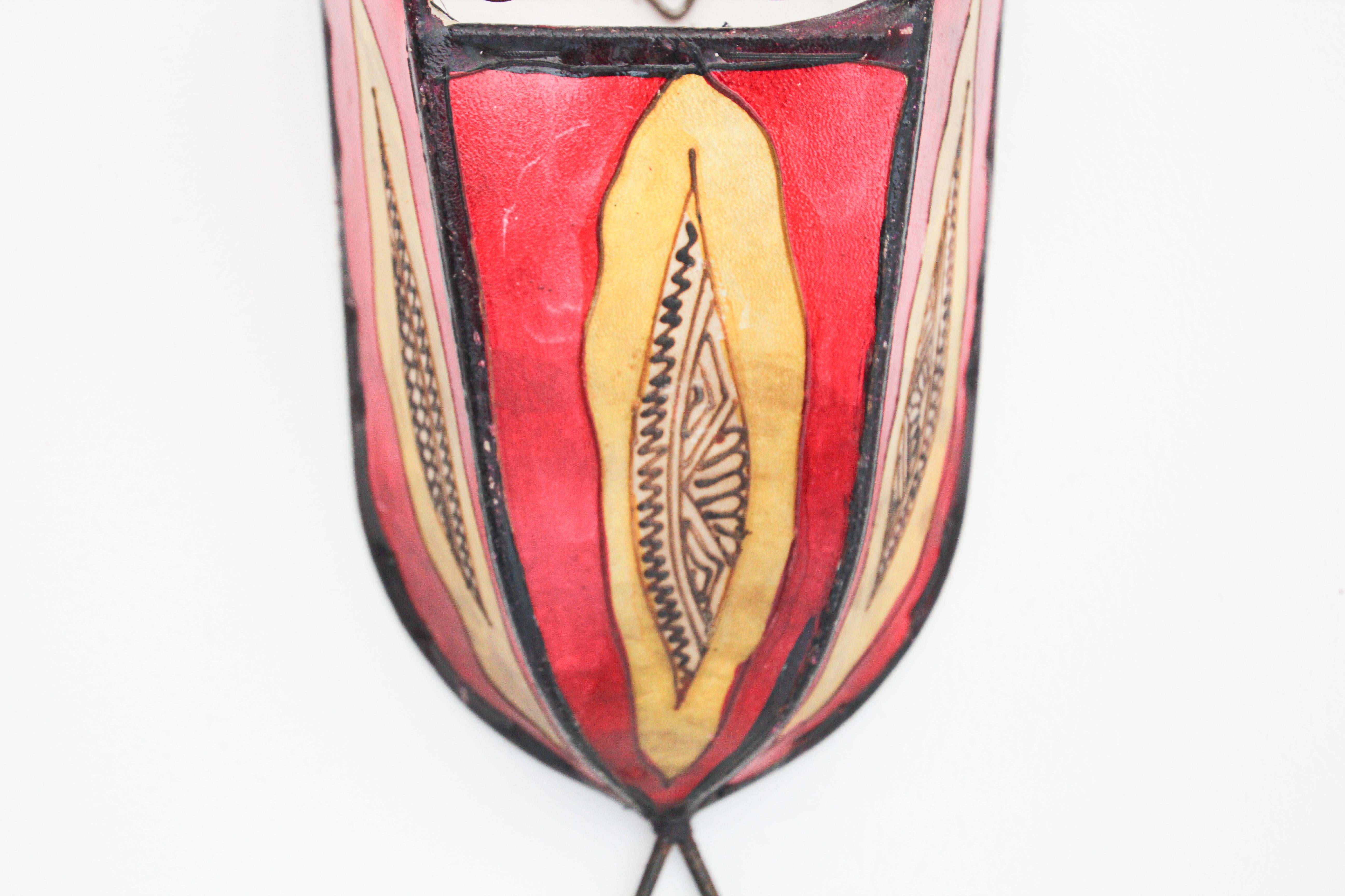 African tribal art parchment wall shade sconce featuring a large curved hide form stitched on iron and hand painted surface.
These Moroccan art pieces could be used as wall lamp shade.
Iron frame covered with hide parchment which has been hand
