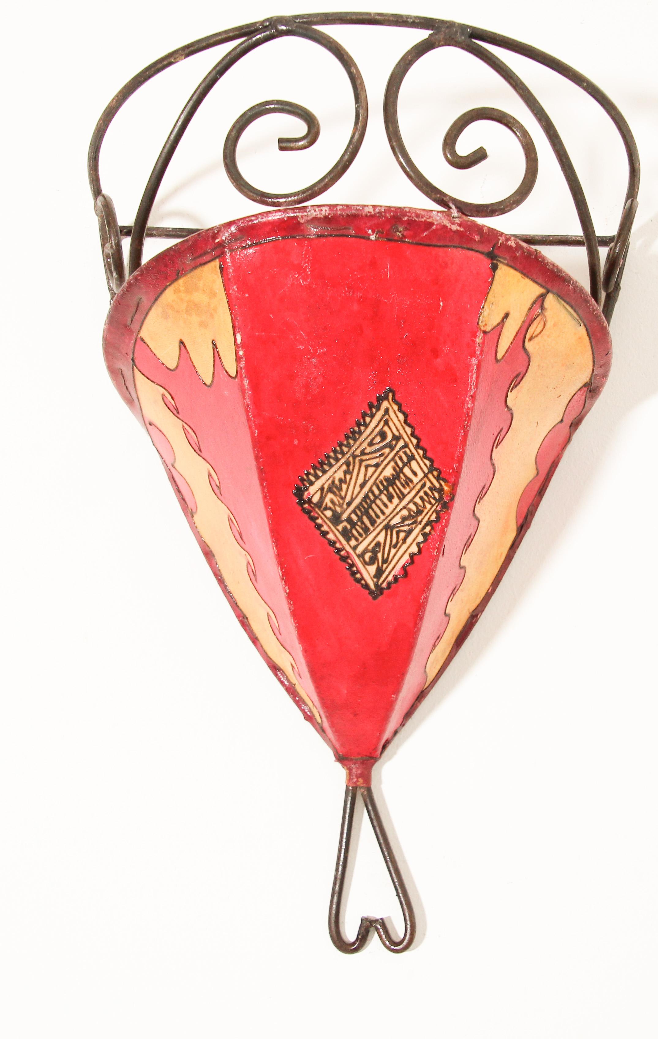 African tribal art parchment wall shade sconce featuring a large curved hide form stitched on iron and hand painted surface.
These Moroccan art pieces could be used as wall lamp shade.
Iron frame covered with hide parchment which has been hand