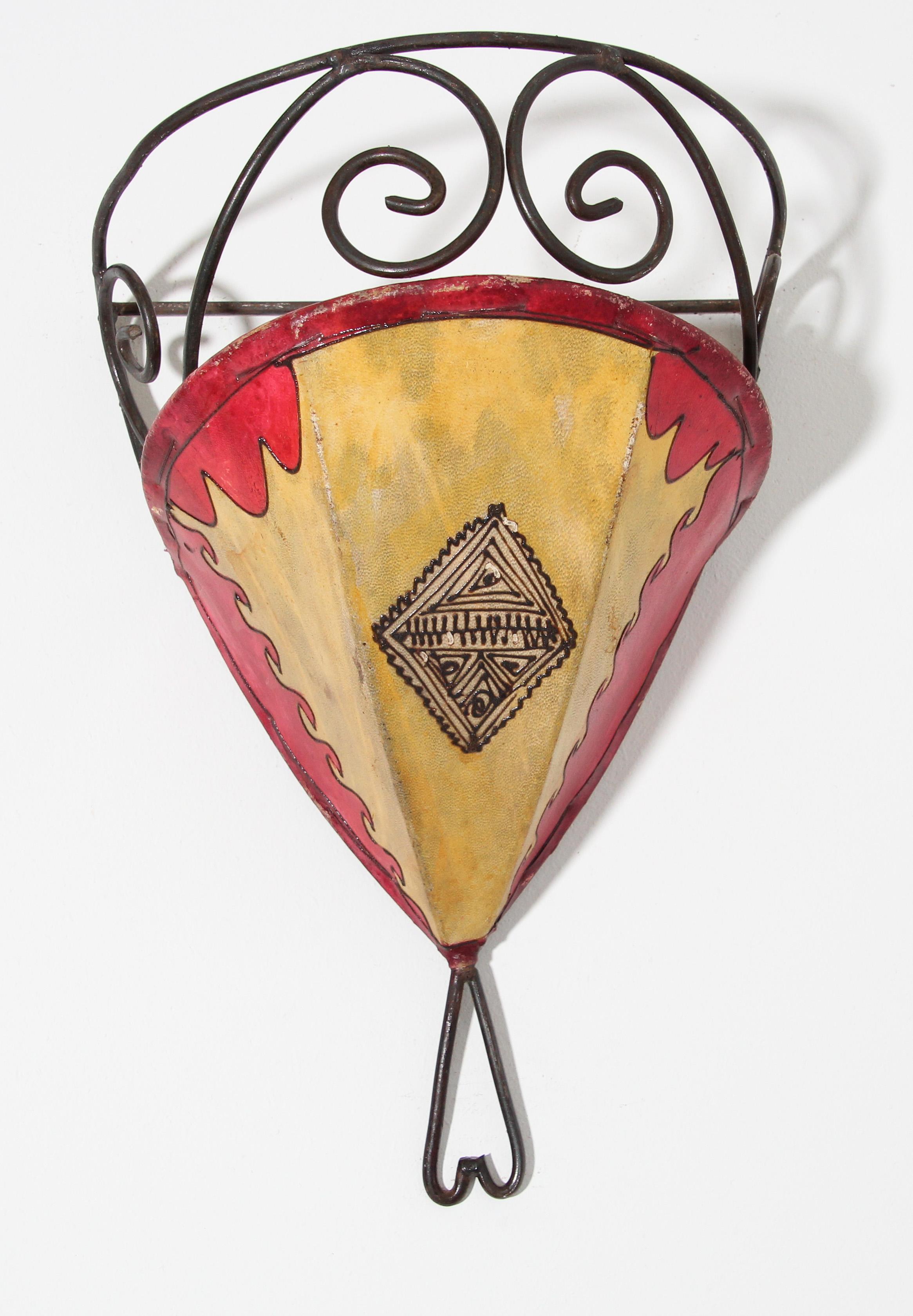 African Tribal Art parchment wall shade sconce featuring a large curved hide form stitched on iron and hand painted surface.
These Moroccan Art pieces could be used as wall lamp shade.
Iron frame covered with hide parchment which has been hand