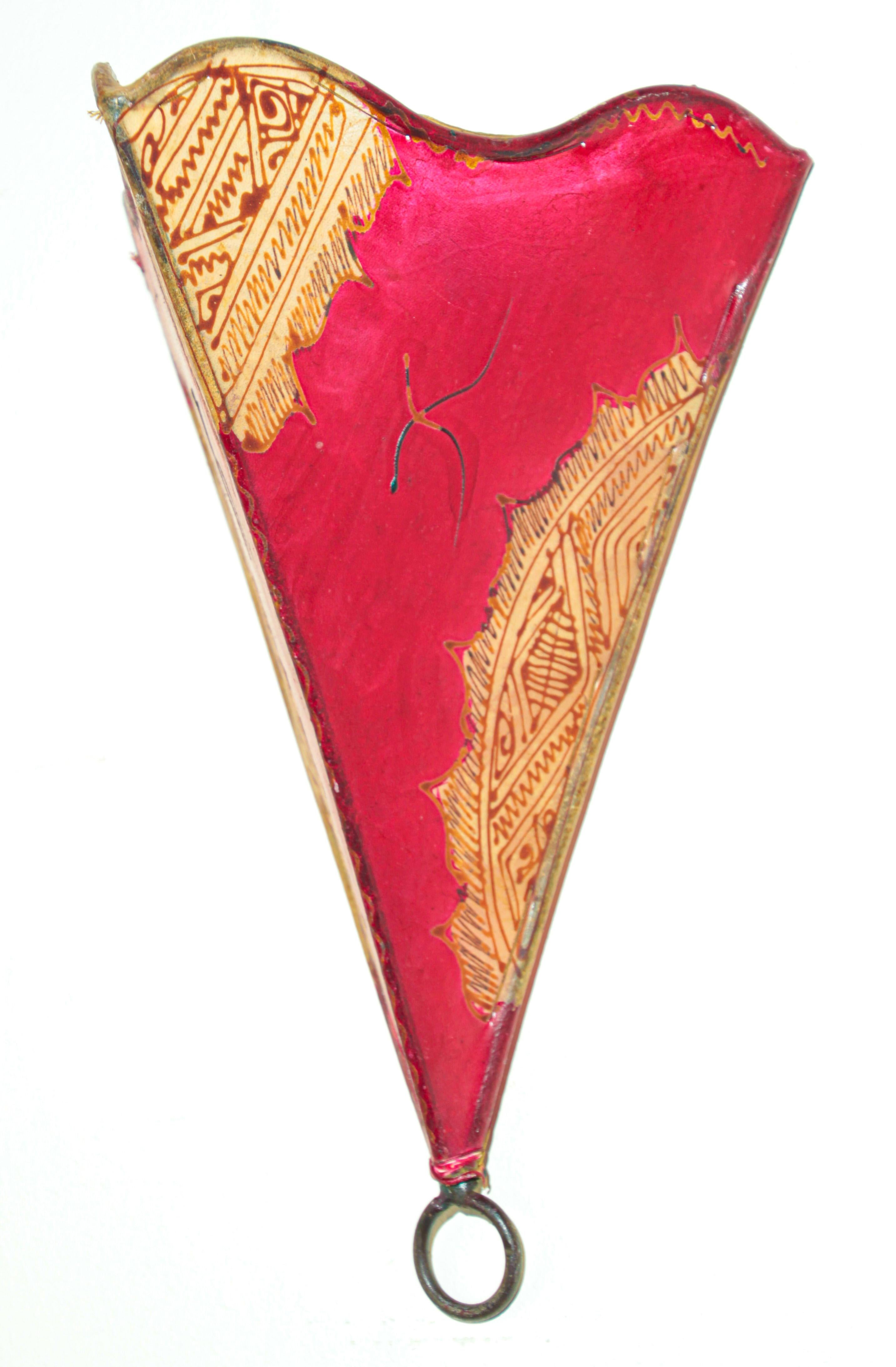 African Tribal Art parchment wall shade sconce featuring a large triangle hide form stitched on iron and hand painted surface.
These Moroccan Art pieces could be used as wall lamp shade.
Iron frame covered with hide parchment which has been hand