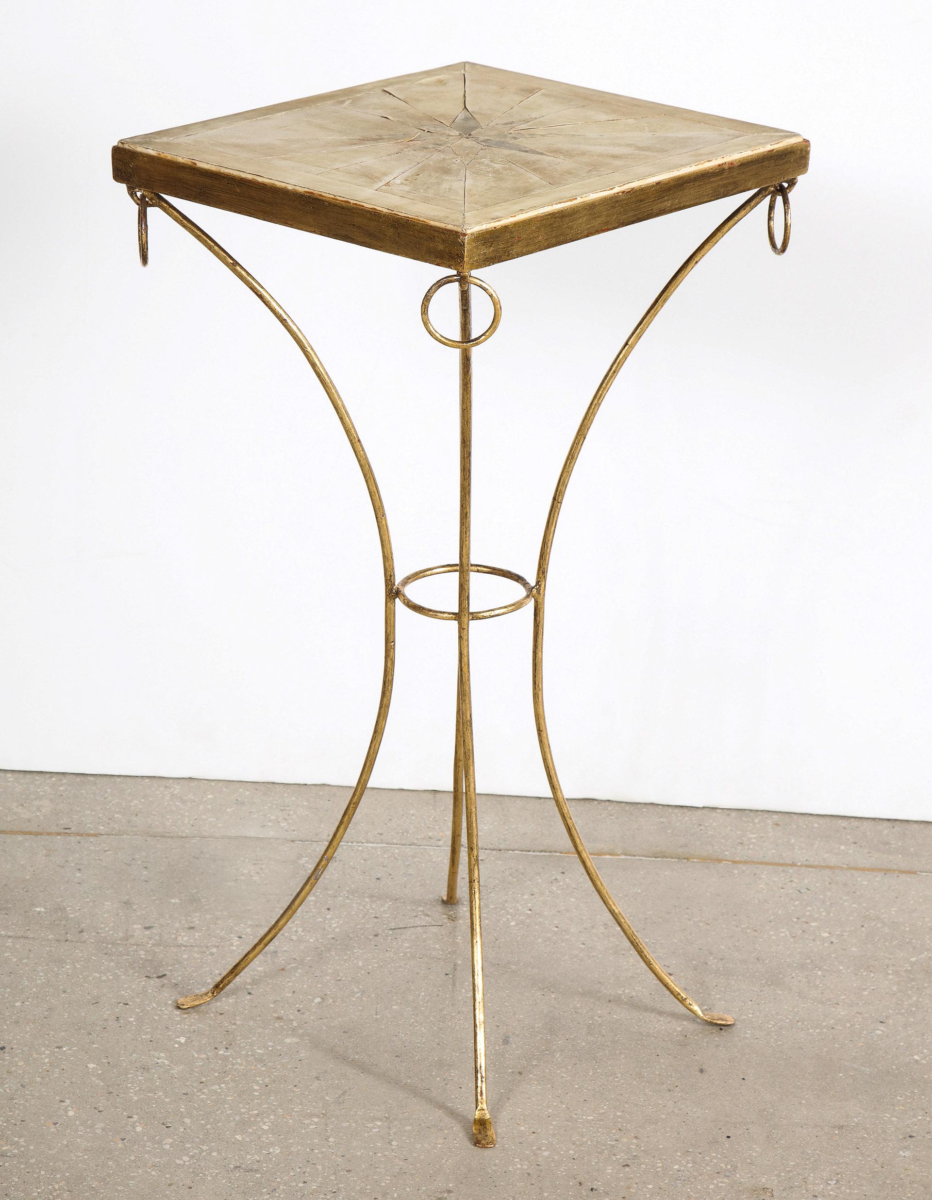 French Art Deco gilt iron and parchment pedestal table, in the manner of Jean-Michel Frank

The top of parchment layered down in a marquetry star pattern, on gilt iron frame supported by gilt iron legs.