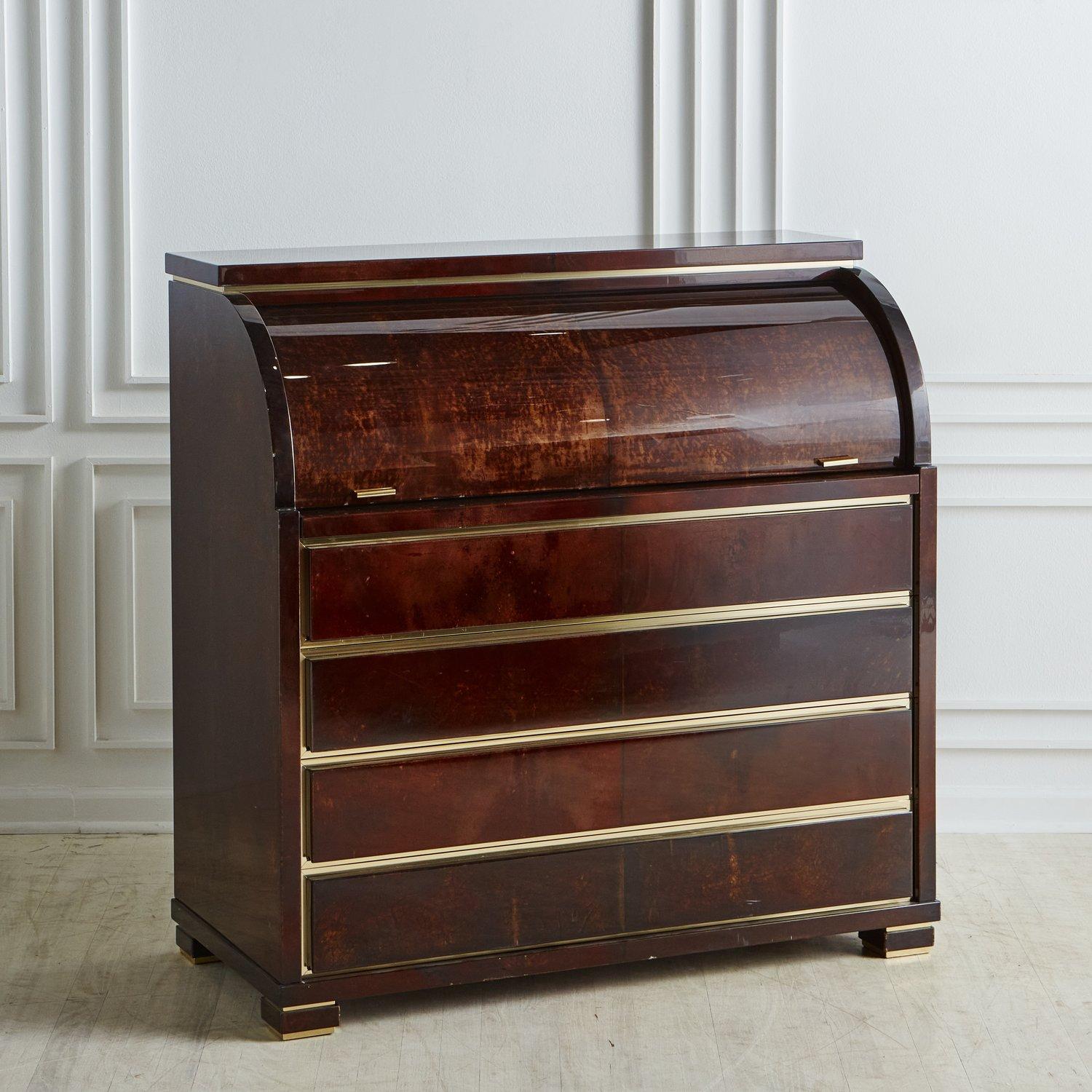 A stunning Italian secretary desk in the style of Aldo Tura. This desk features a lacquered parchment finish in a deep brown hue with subtle color variations. Based on the 18th century escritoire, this Mid Century beauty has a curved retractable top