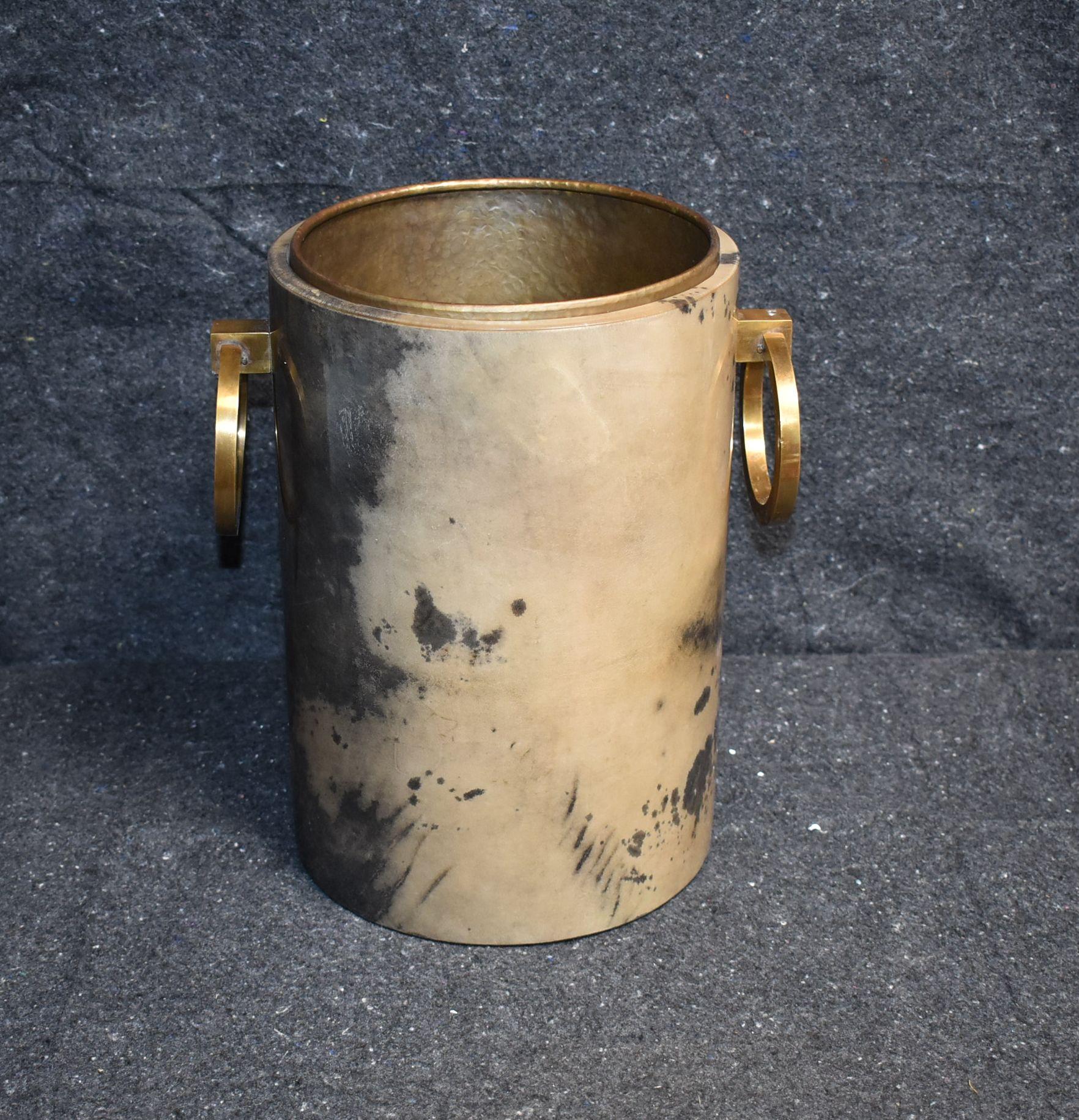 Trash can (also can be use as Champagne bucket) cover with goatskin and brass handles.
Inside bucket is made of copper finish.
Parchment is in varying shades of very light and dark gray. (High gloss polyester resin filled finish).

Additional