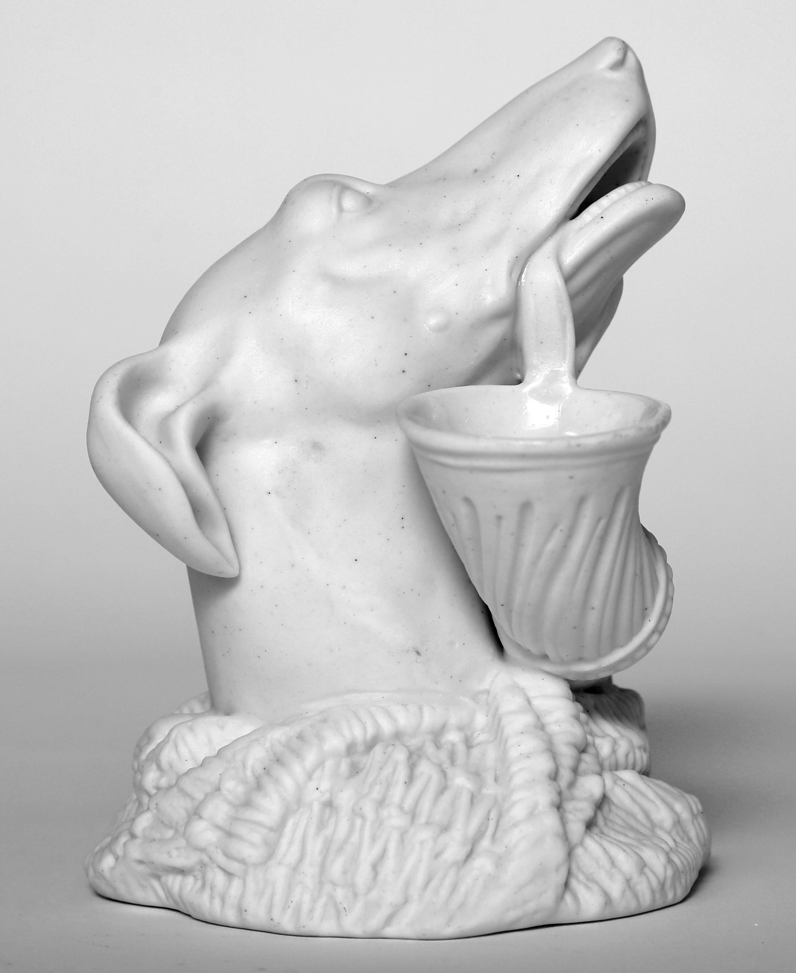 Parian vase of a greyhound holding a powder horn. Parian ware was created form a liquid porcelain which enabled the creator to achieve exacting detail. This piece if not used as a vase is decorative enough to put on a table, shelf or desk.
