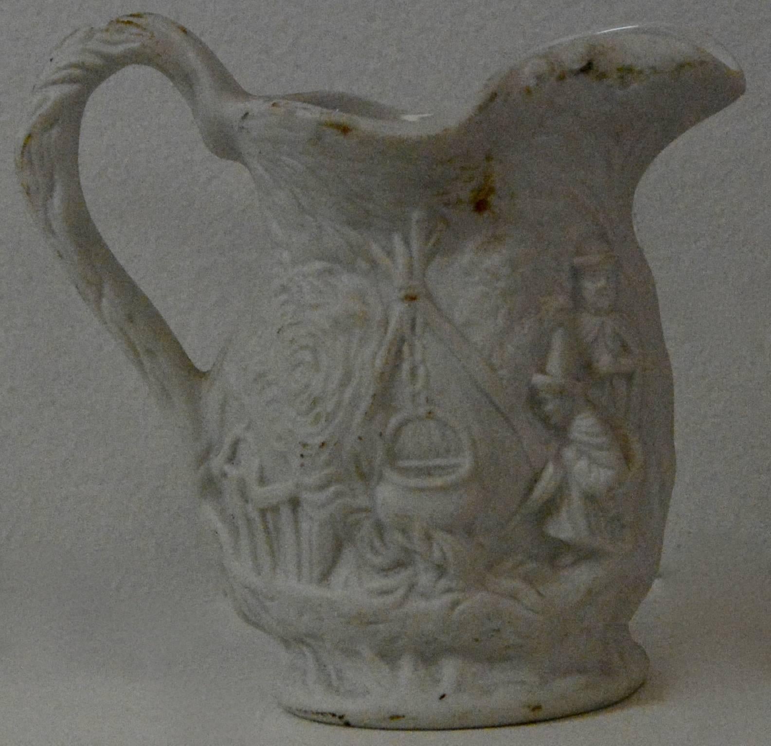 We are offering you a lovely Parian ware miniature pitcher formed from white earthenware. The details on the piece are very detailed the pitcher is stamped on the bottom.