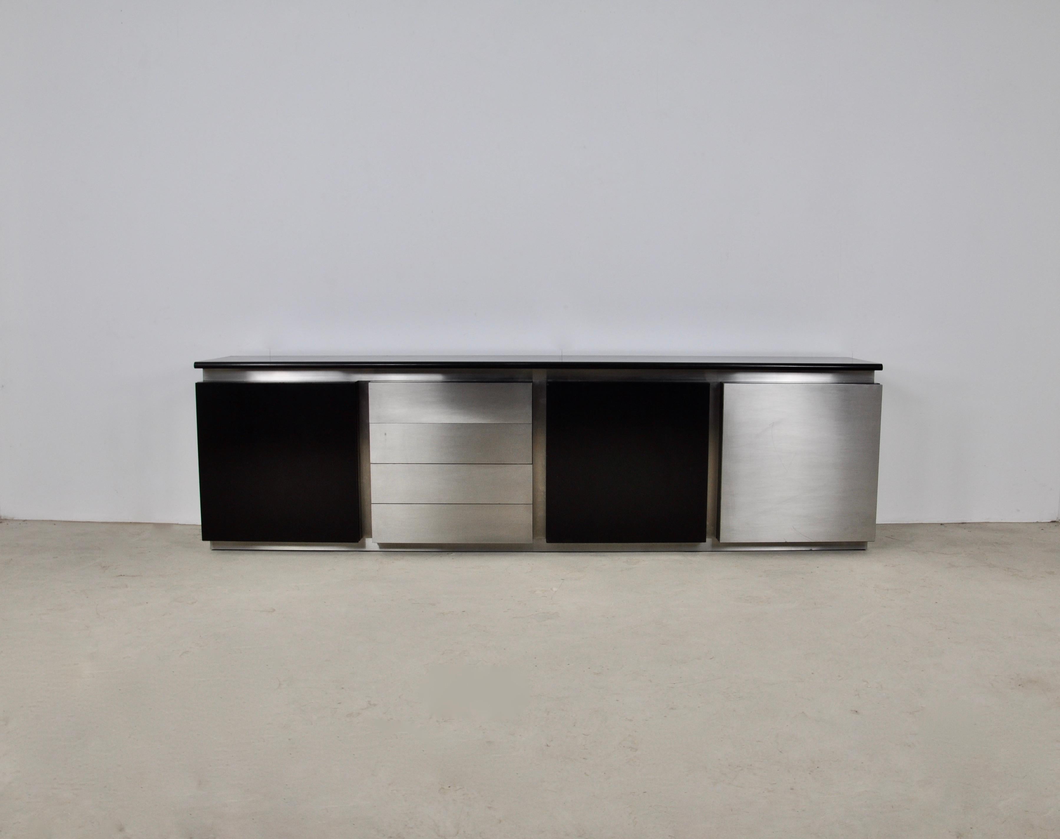 Sideboard in black stained wood and metal. It consists of 4 drawers and 3 doors each containing a glass shelf.
Wear due to time and age of the sideboard.
 