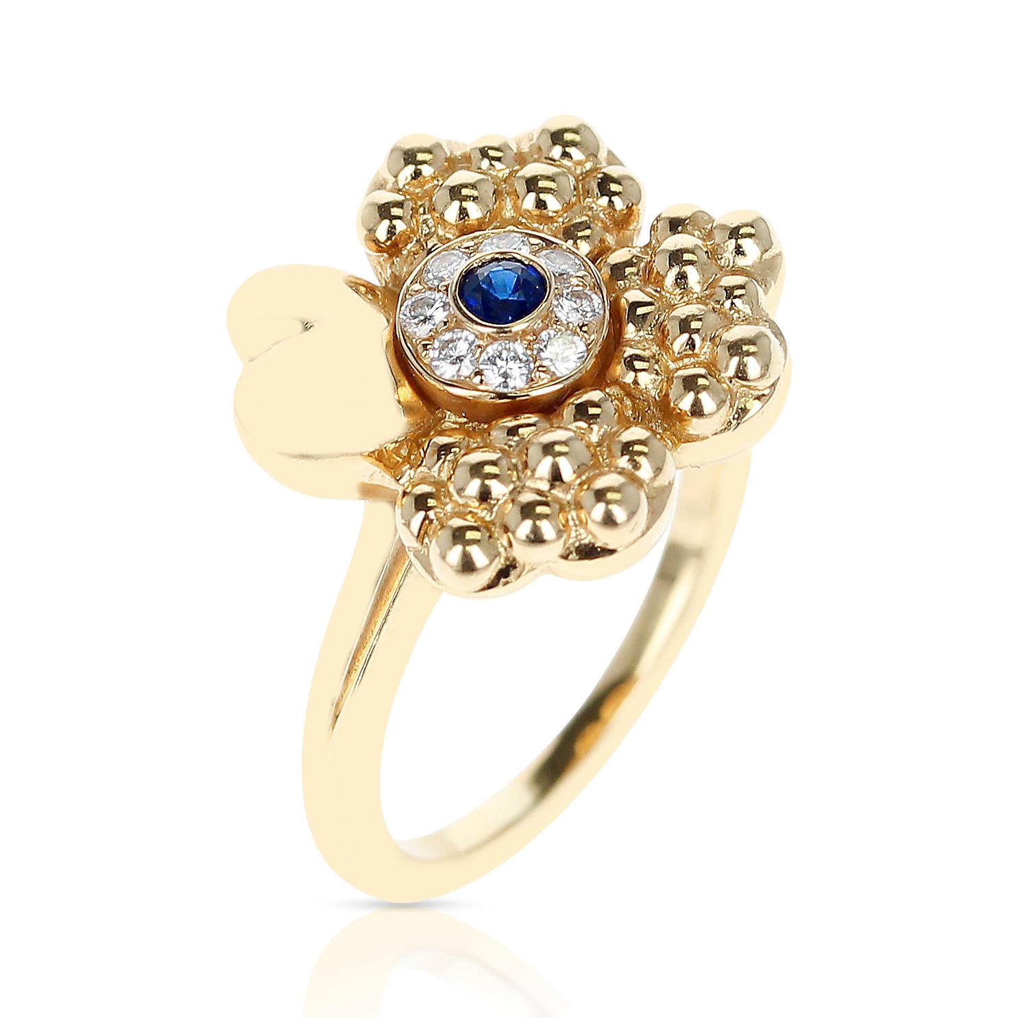 A Paris Clover Ring with Diamonds and a Center Blue Sapphire made in 18 Karat Yellow Gold. Total Weight: 6.96 grams. Ring Size US 5.50. 


