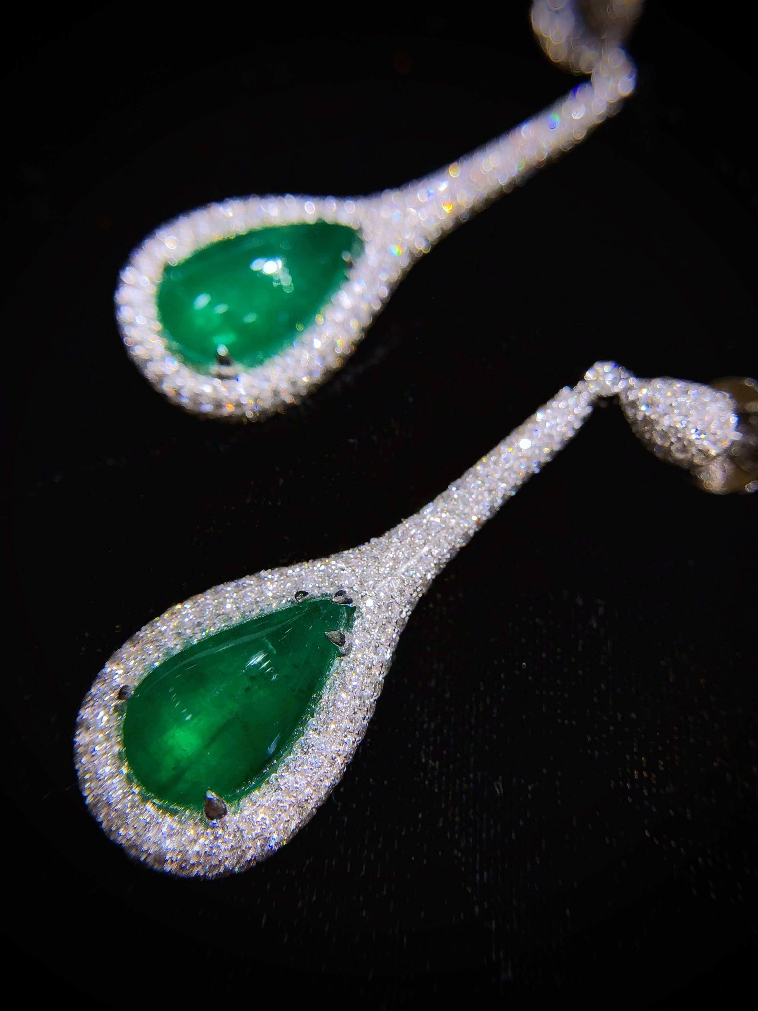 PARIS Craft House 11.48ct Emerald Diamond Earring in 18 Karat White Gold.

- 2 Teardrop Cabochon Emeralds/11.48ct
- 498 Round Diamonds/3.94ct
- 18K White Gold/12.38g

Designed and crafted at PARIS Craft House.
