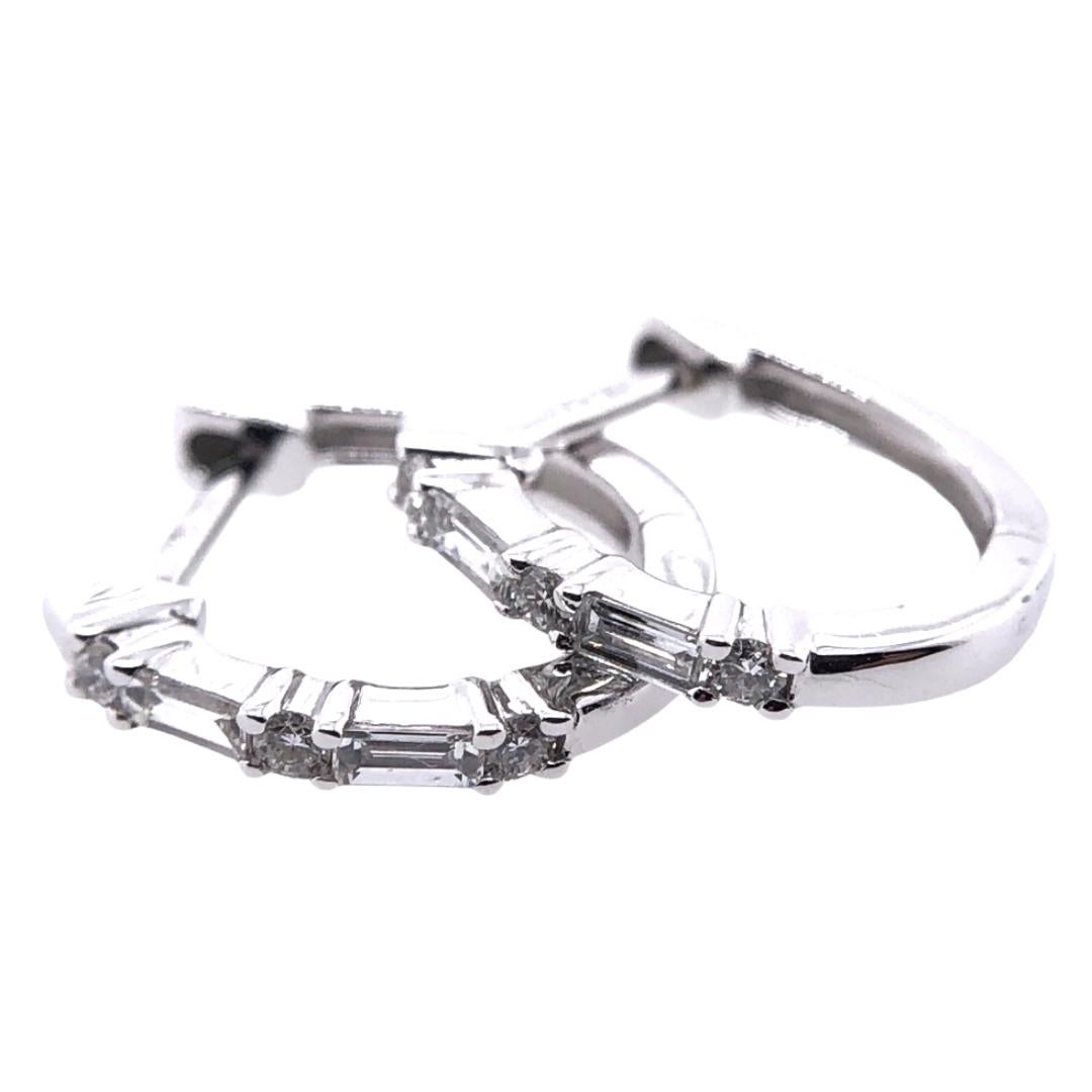 PARIS Craft House Diamond Hoop Earrings. Featured in this article are these charming Diamonds carved in Baguette cuts. Crafted in 18 Karat White Gold, these lucid stones are accompanied with Round Diamonds of matching size and cuts. These stones are