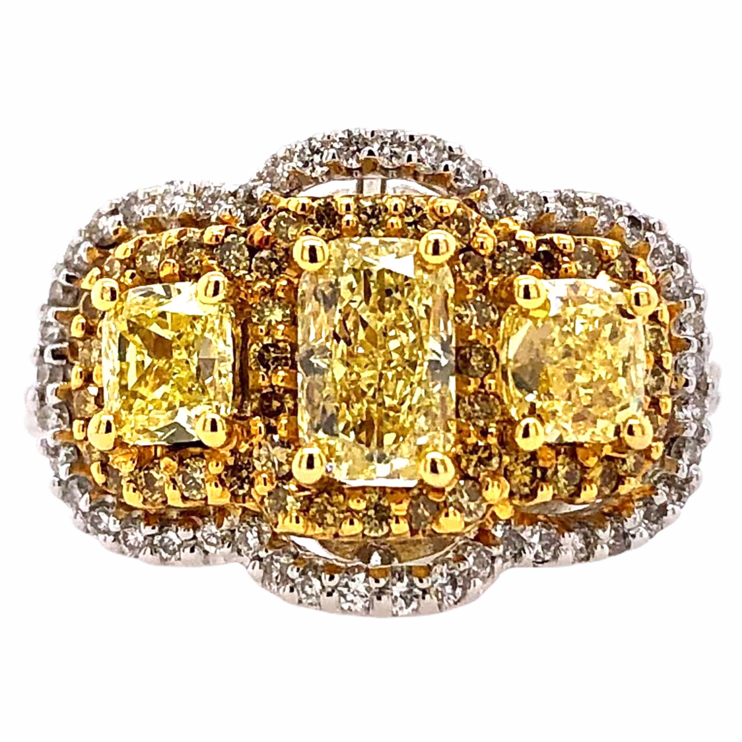 PARIS Craft House Fancy Yellow Diamond Three Stone Ring in 18 Karat White/Yellow Gold.

- 3 Cushion-cut Fancy Yellow Diamonds/1.36ct
- 44 Yellow Diamonds/0.24ct
- 70 Round Diamonds/0.41ct
- 18K White/Yellow Gold/6.83g

Designed and crafted at PARIS