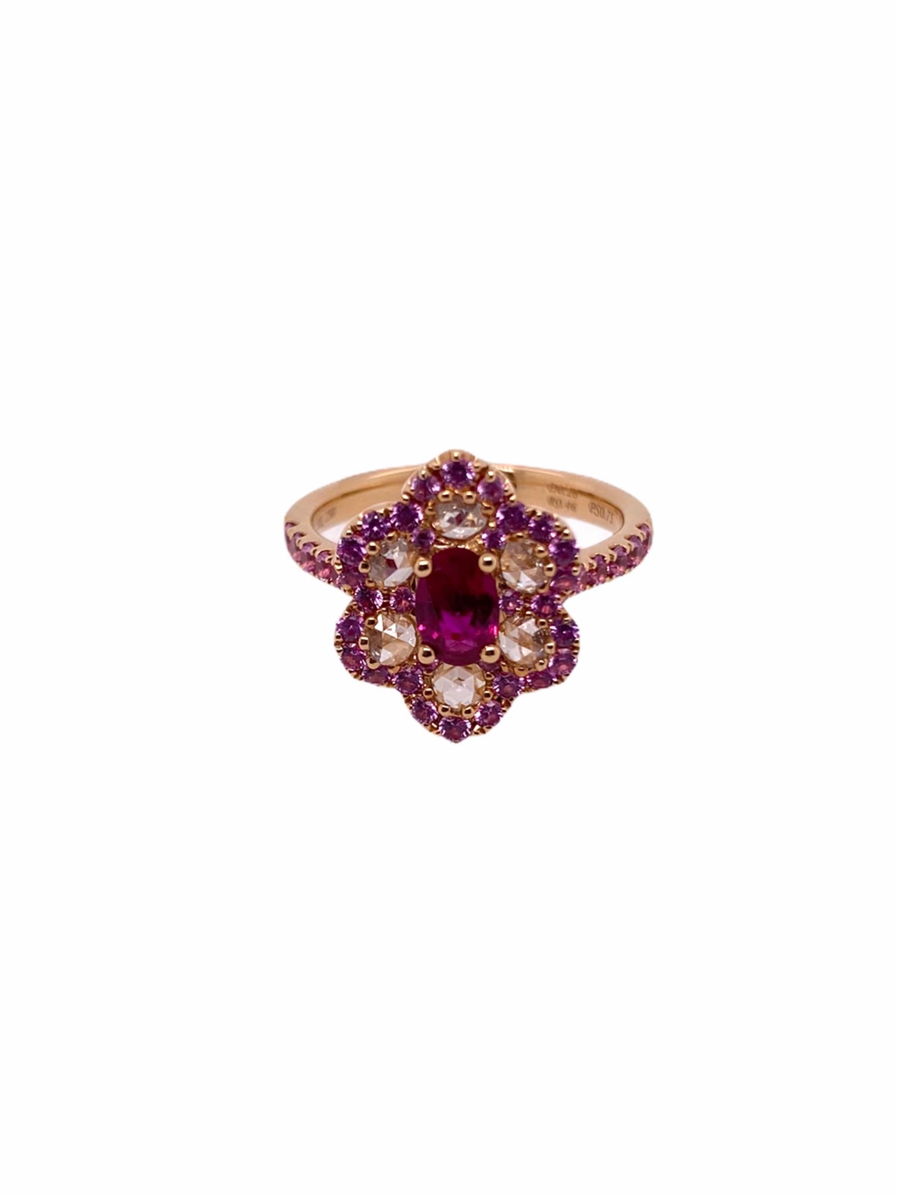 PARIS Craft House Minimal Floral Ring. Featured on this is a combination of different gems. At the center, sits a 0.46ct Oval-cut Ruby adorned with 6 Round Diamonds making the silhouette of a flower. Around them are  42 Pink Sapphires beautifully