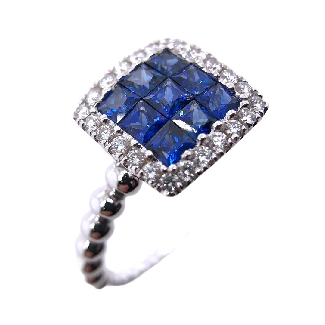 PARIS Craft House Sapphire Diamond Cluster Ring in 18 Karat White Gold.

- 9 Princess-cut Blue Sapphires/1.00ct
- 24 Round Diamonds/0.21ct
- 18K White Gold/4.17g
- Ring size/US 6.25

Designed and crafted at PARIS Craft House.