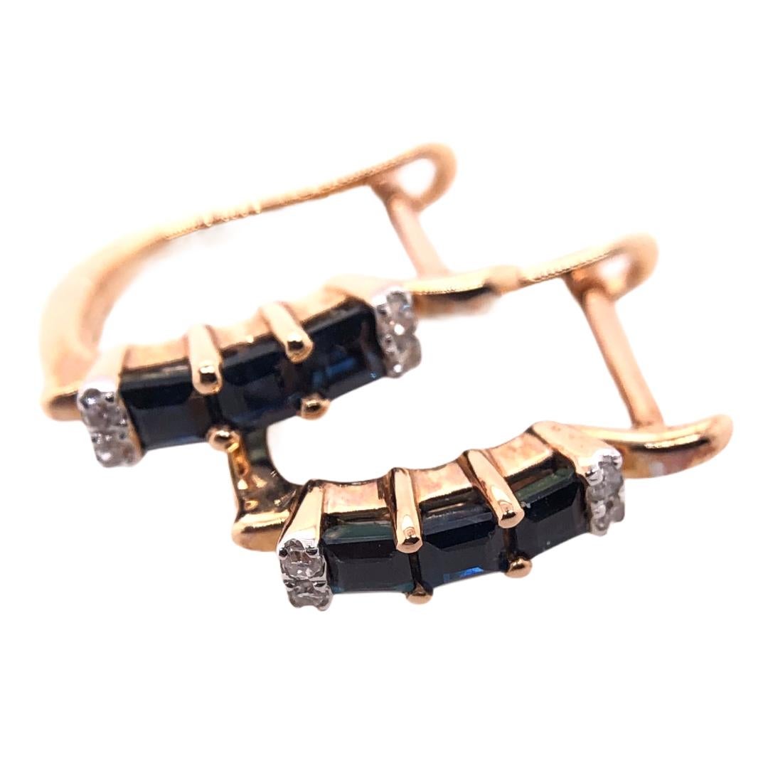 PARIS Craft House Sapphire Diamond Hoop Earrings. Featured in this article are these 6 royal Sapphires carved in Baguette cuts. Crafted in 14 Karat Rose Gold, the blue stones are adorned with Round Diamonds of matching size and cuts. These stones