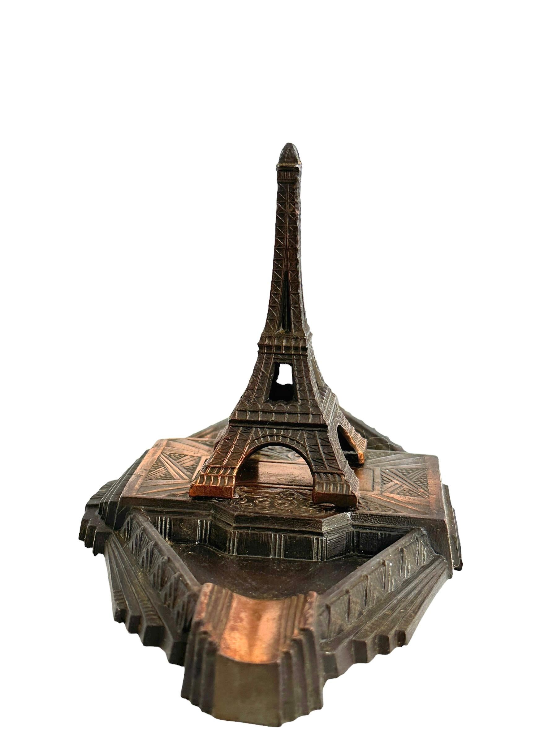 A decorative Eiffel Tower souvenir building sculpture ashtray. Some wear with a nice patina, but this is old-age. Made of metal. This item was bought as a souvenir in Paris, France and was made probably in the 1930s or older. Found at an estate sale