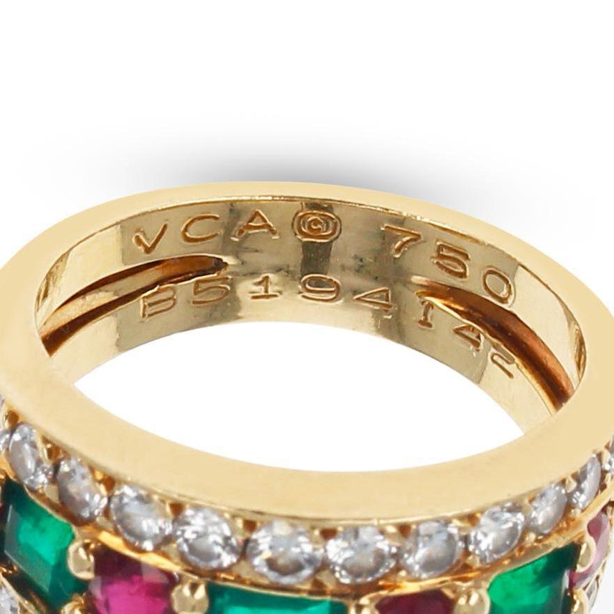 A Precious Stone Van Cleef & Arpels Rectangular Emerald and Round Ruby and Diamond Wide Band Cocktail Ring made in 18K Yellow Gold. There are 3 Emerald-Cut Emeralds, where is middle one is large and the two others are smaller and a pair. There are 4