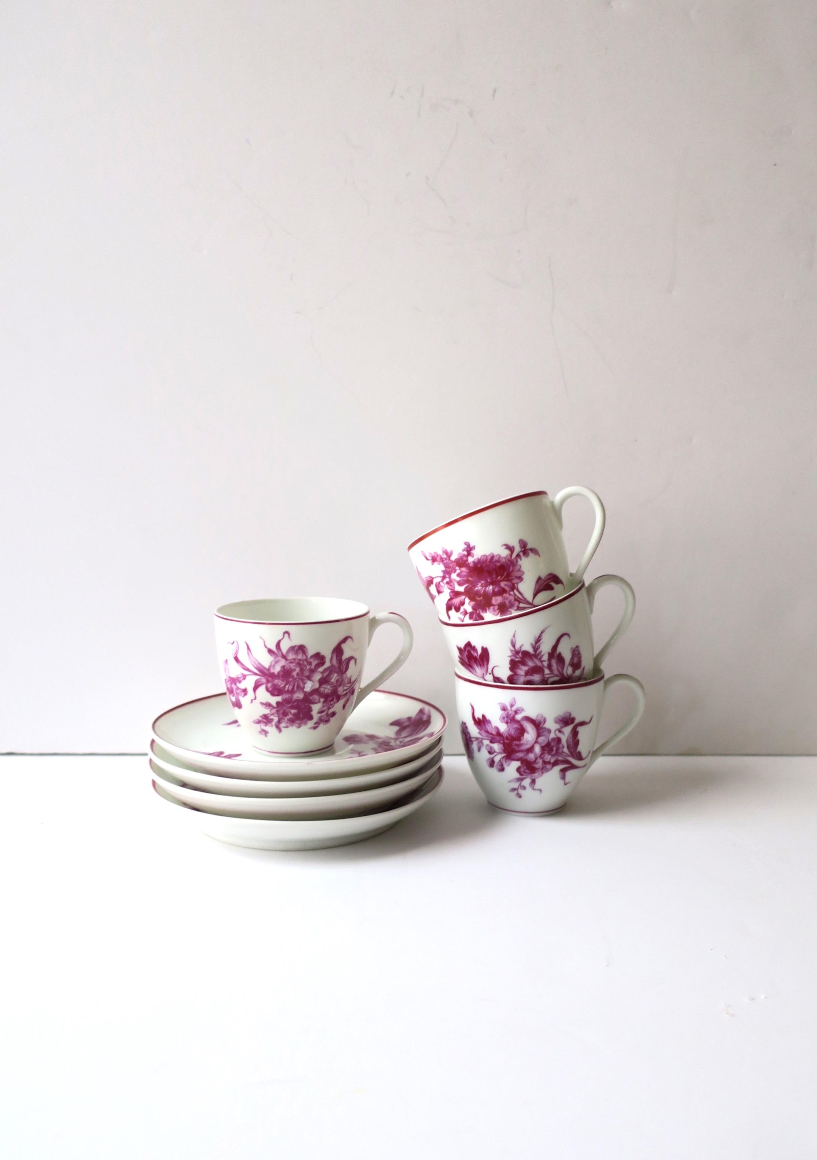 A very beautiful and rare set of four (4) French porcelain coffee espresso or tea demitasse cup and saucer set in white porcelain and magenta pink, by Toy-Le Rosey, Paris, France, circa early-20th century. Each set has a different magenta pink