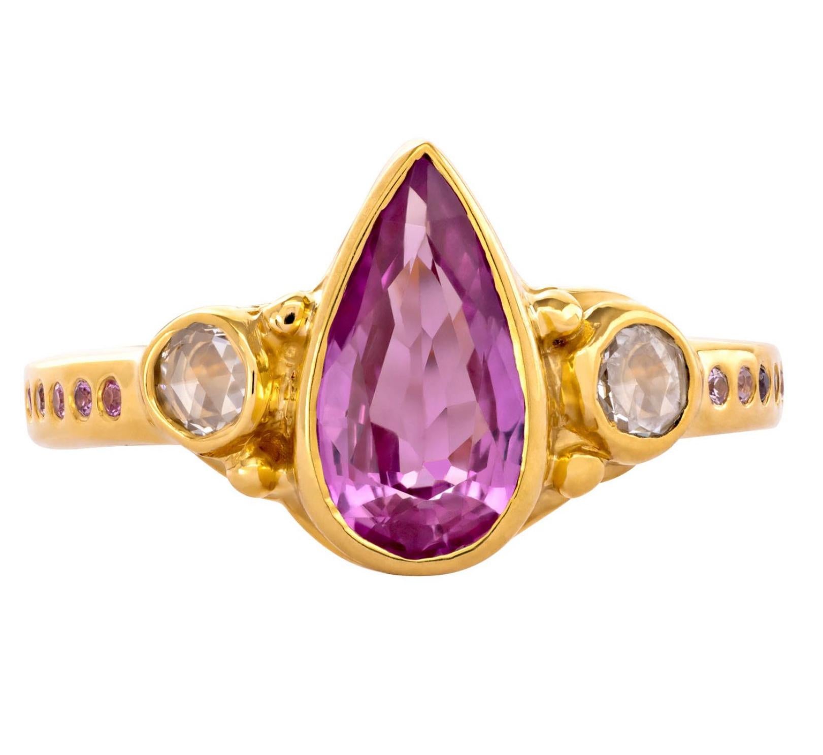 From the Tale of Five Rings Collection, this 22K gold ring has a stunning 2.35 carat pink - pear shaped sapphire center stone with 3mm rose cut side diamonds and 1mm pink sapphires surrounding the band. This ring is completely hand crafted and hand