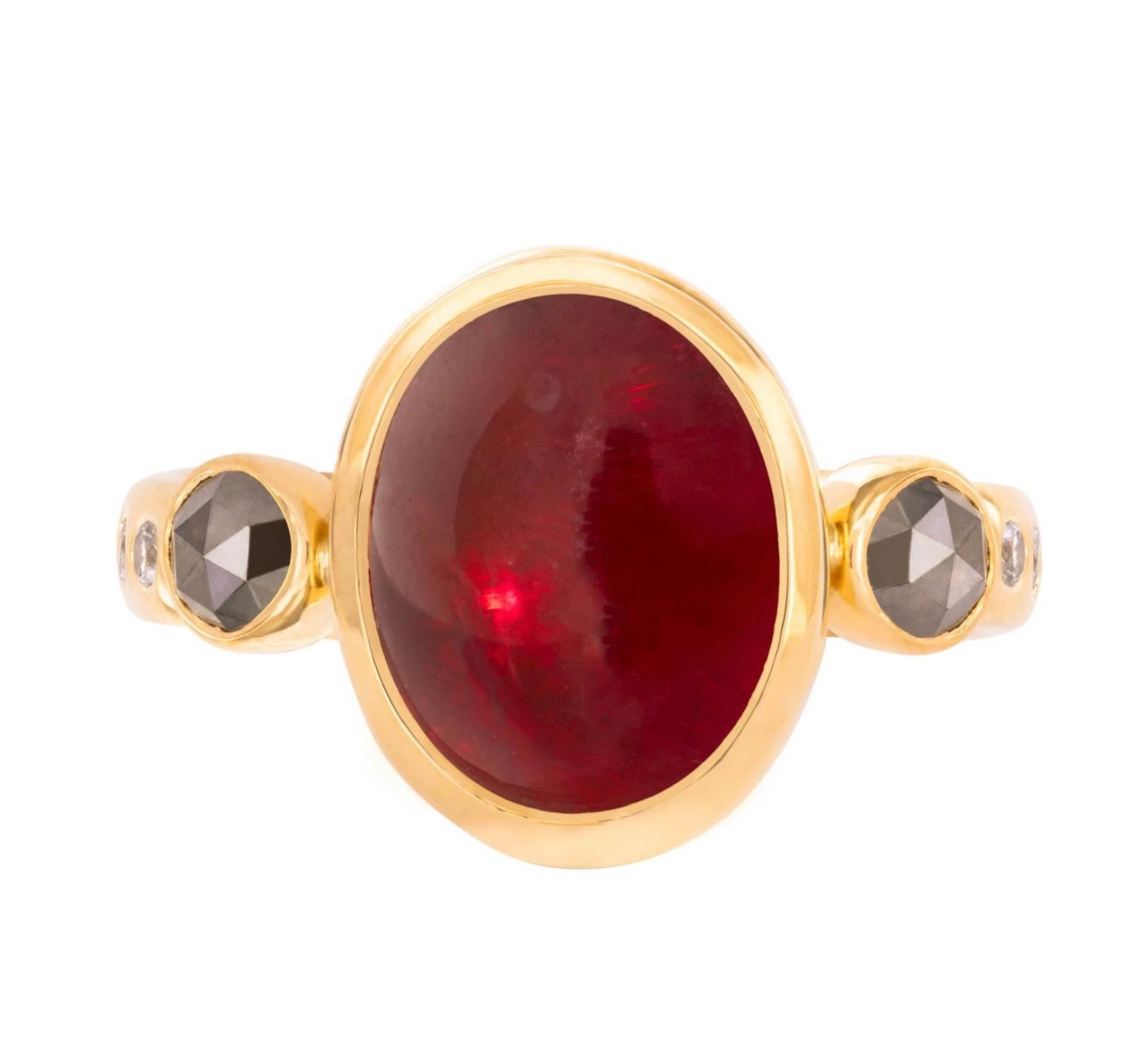 From the Tale of Five Rings Collection, this 22K gold ring has a stunning  5.79 carat smooth, rubellite tourmaline cabochon, 3mm rose cut grey side diamonds, 1.6mm brilliant grey diamonds surrounding the band. This ring is completely hand crafted