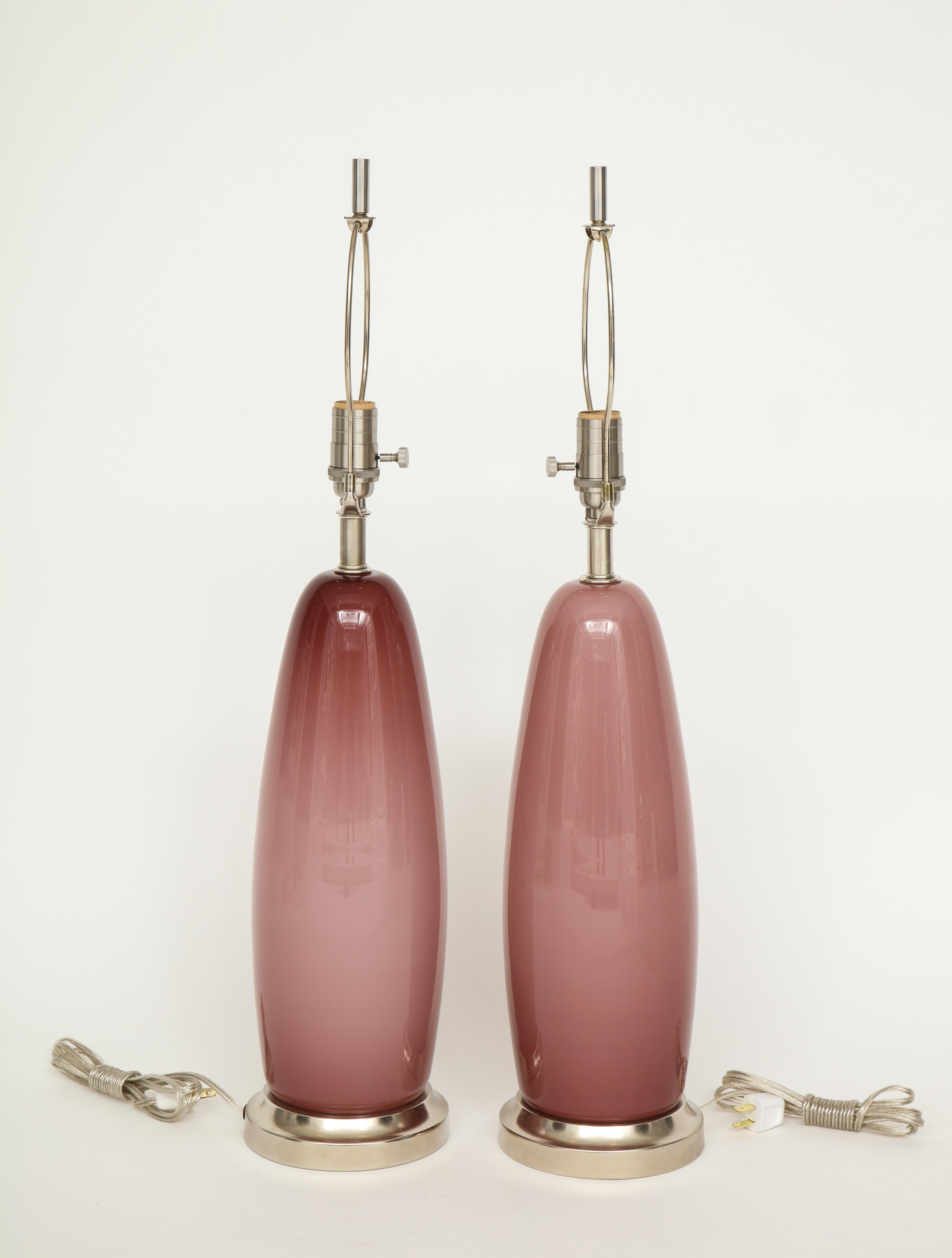 Pair of Murano glass lamps in a modern burnt Paris Pink color mounted on brushed nickel bases. Rewired for use in the USA. 100W Max bulbs. Glass body measures 17.75 inches tall.