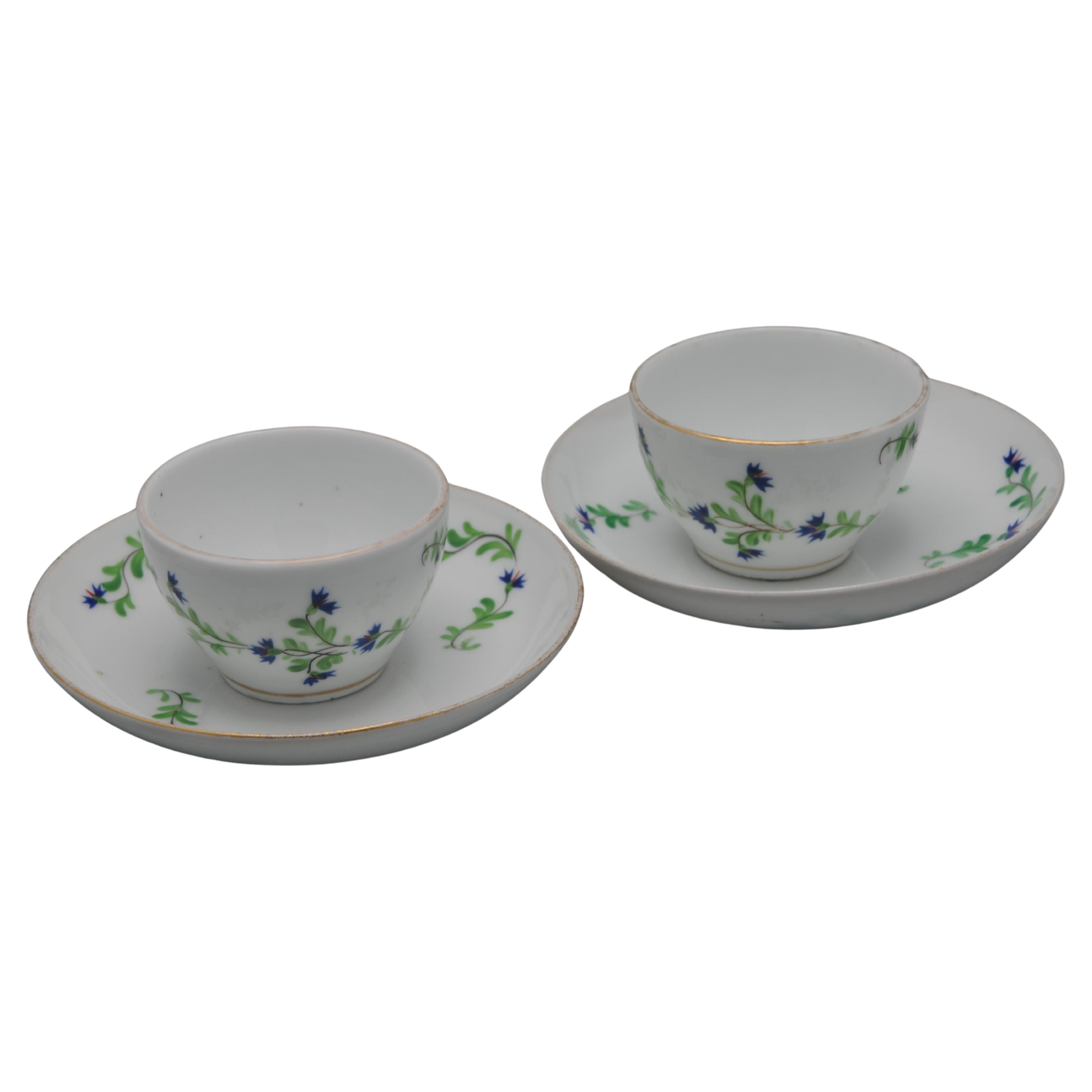 Set of 2 cups and saucers with decoration of corn flower sprays and flower buds.  
The cornflower (barbeau in French) was eligibly Marie Antoinettes favorite flower, as it was the color of her eyes.  In 1871 Sevres created the service 'Perles et