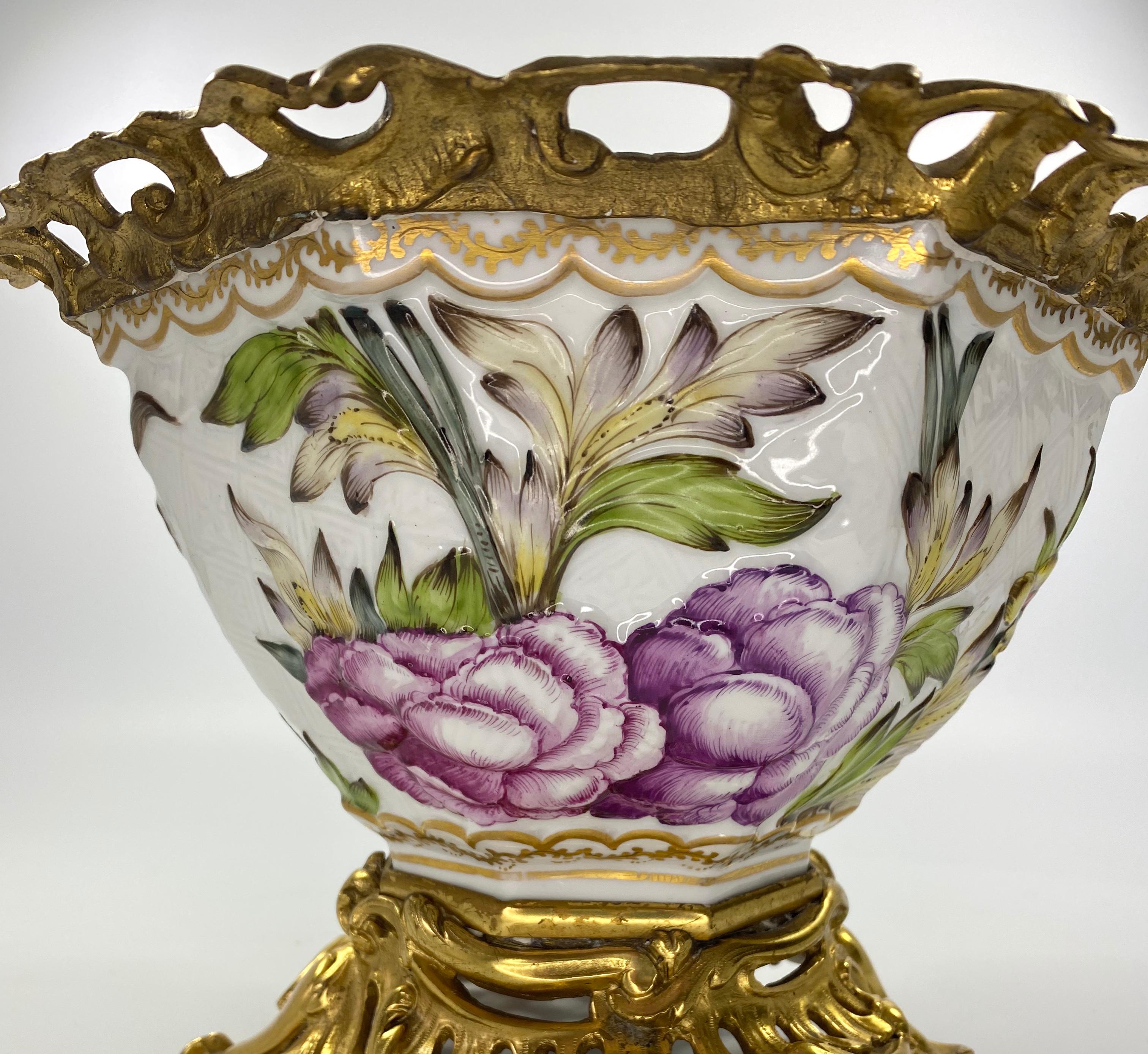 Paris ormolu mounted porcelain bowl, circa 1880. The large bowl moulded and vibrantly enameled with a Lion Dog, amongst flowering plants. All upon a lightly moulded cell diaper ground.
Having good quality rococo style ormolu mounts, to both the rim