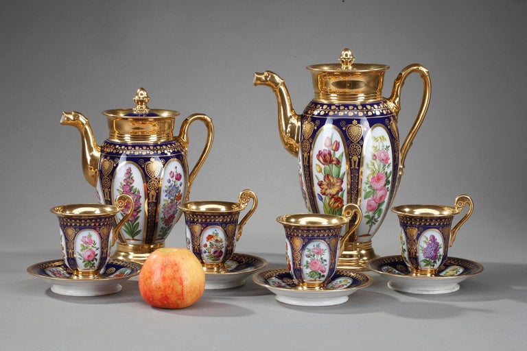 Paris porcelain coffee service in Charles X-style. Each of the 6 exquisite pieces features delicately hand painted cartouches with polychrome flower bouquets on white and dark blue background accented with gilt borders.

This service comprises:
-