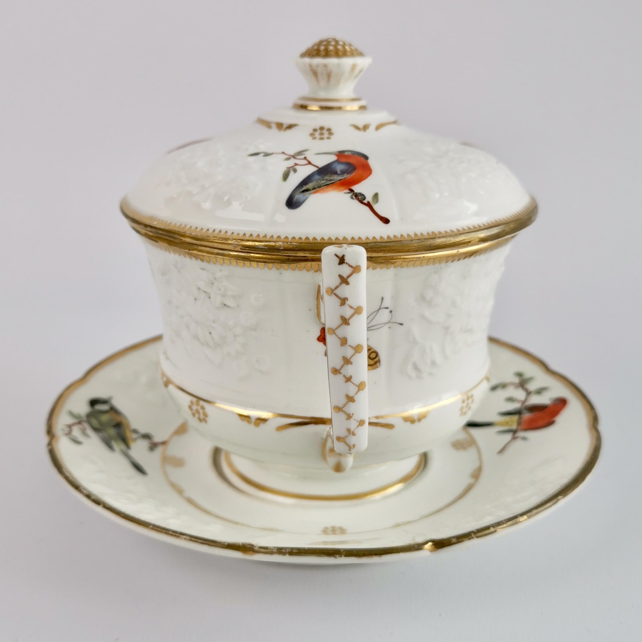 This is a beautiful écuelle (broth bowl) with a stand and cover, made by a Paris factory in about 1820. The set has a white ground colour with blind moulding and beautiful hand painted birds and butterflies.
 
This set has some restoration and is