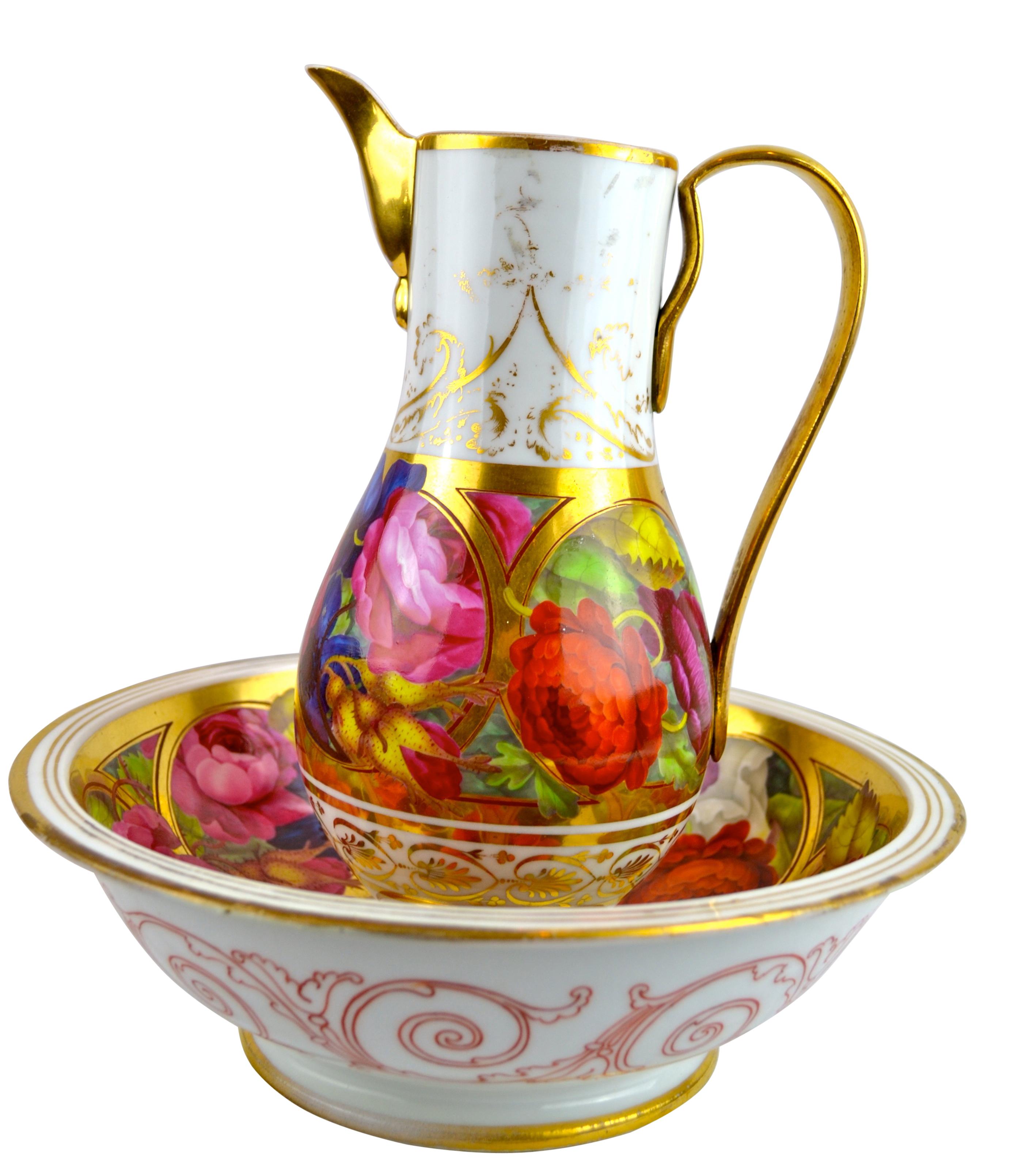 A Paris porcelain ewer; (finial repaired) and matching basin, having brightly painted flowers to both; some rubbing to the ewer.

 