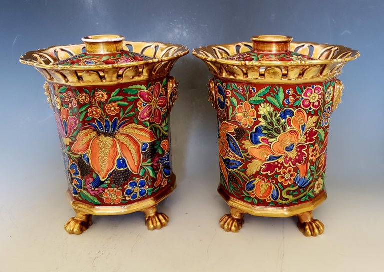 Paris Porcelain incense holders,
Attributed to Jacob Petit,
circa 1840.

The pair of Paris porcelain urns are incense holders with pierced covers. The dodecagon shaped urns (twelve-sided) are raised on four gilt animal feet and have a gilt band